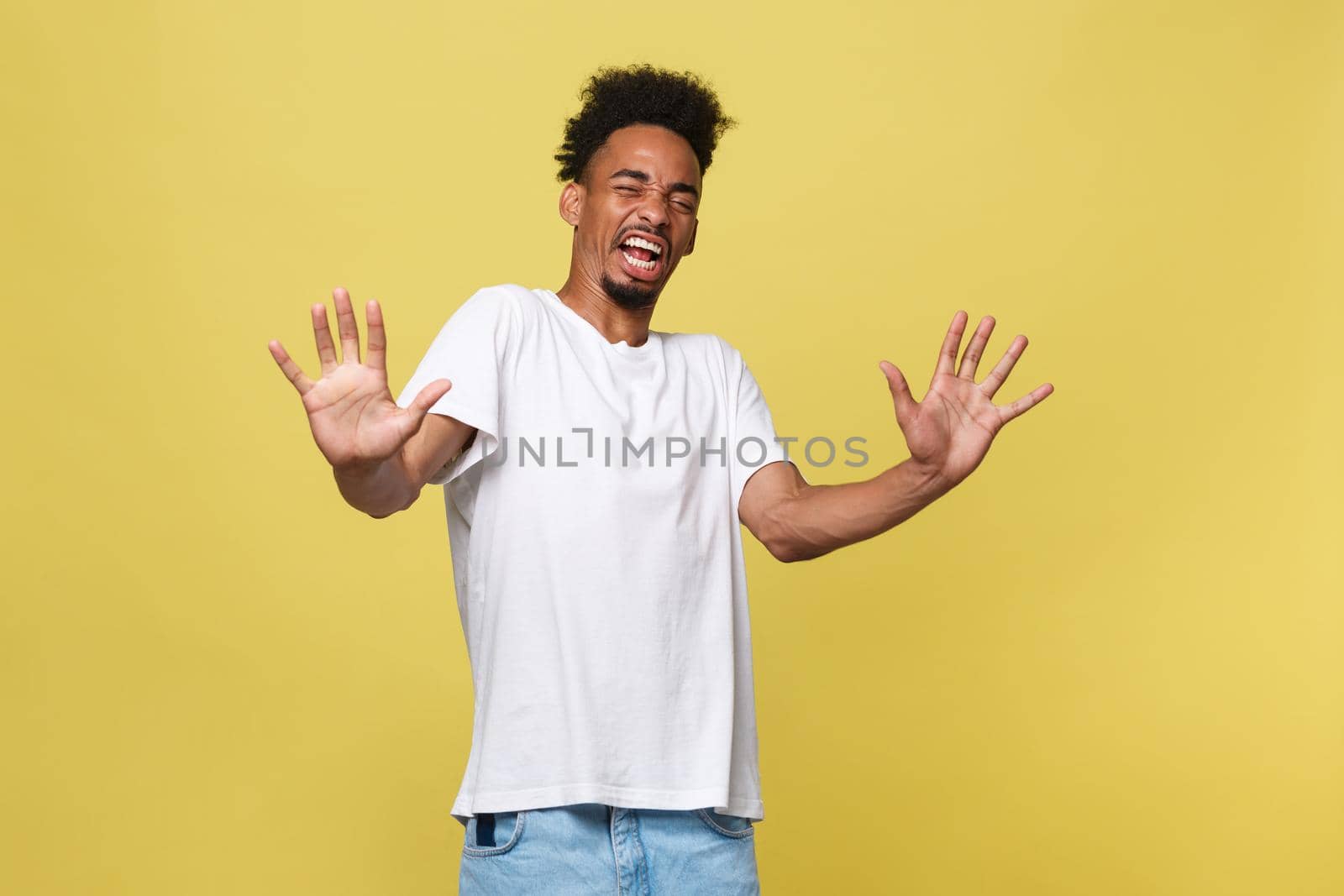 Portrait furious angry annoyed displeased young man raising hands up to say no stop right there isolated orange background. Negative human emotion, facial expression, sign, symbol, body language