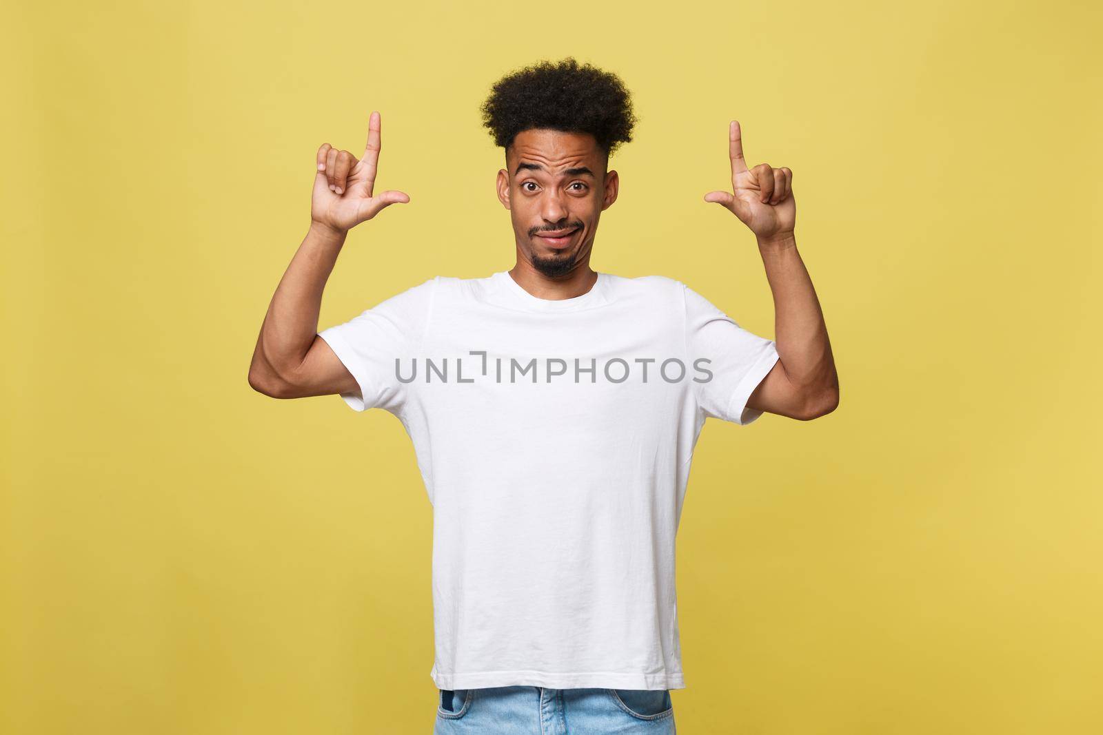 serious dark-skinned African American young man shows a finger upwards.