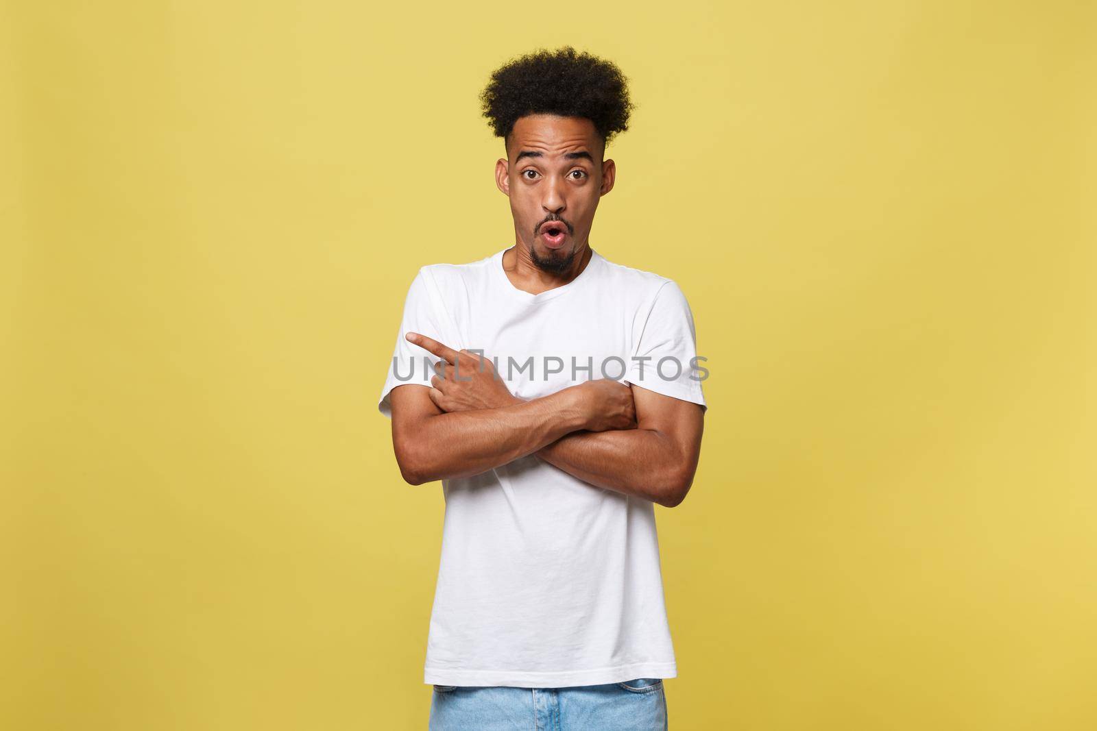 Young handsome african american man over yellow background pointing upwards. by Benzoix