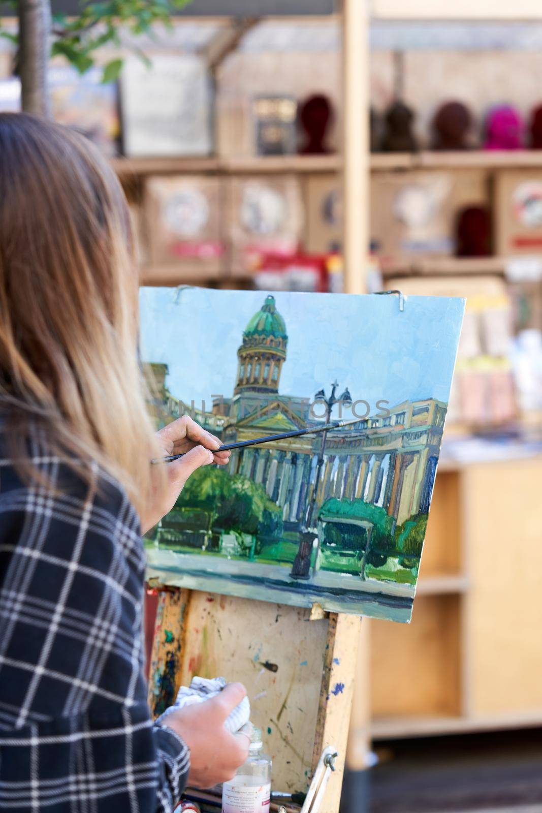 An unknown artist paints the Kazan Cathedral on a street in St. Petersburg by vizland