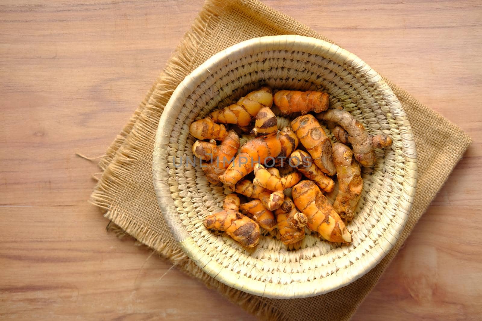 detail shot of turmeric root in bowl on table
