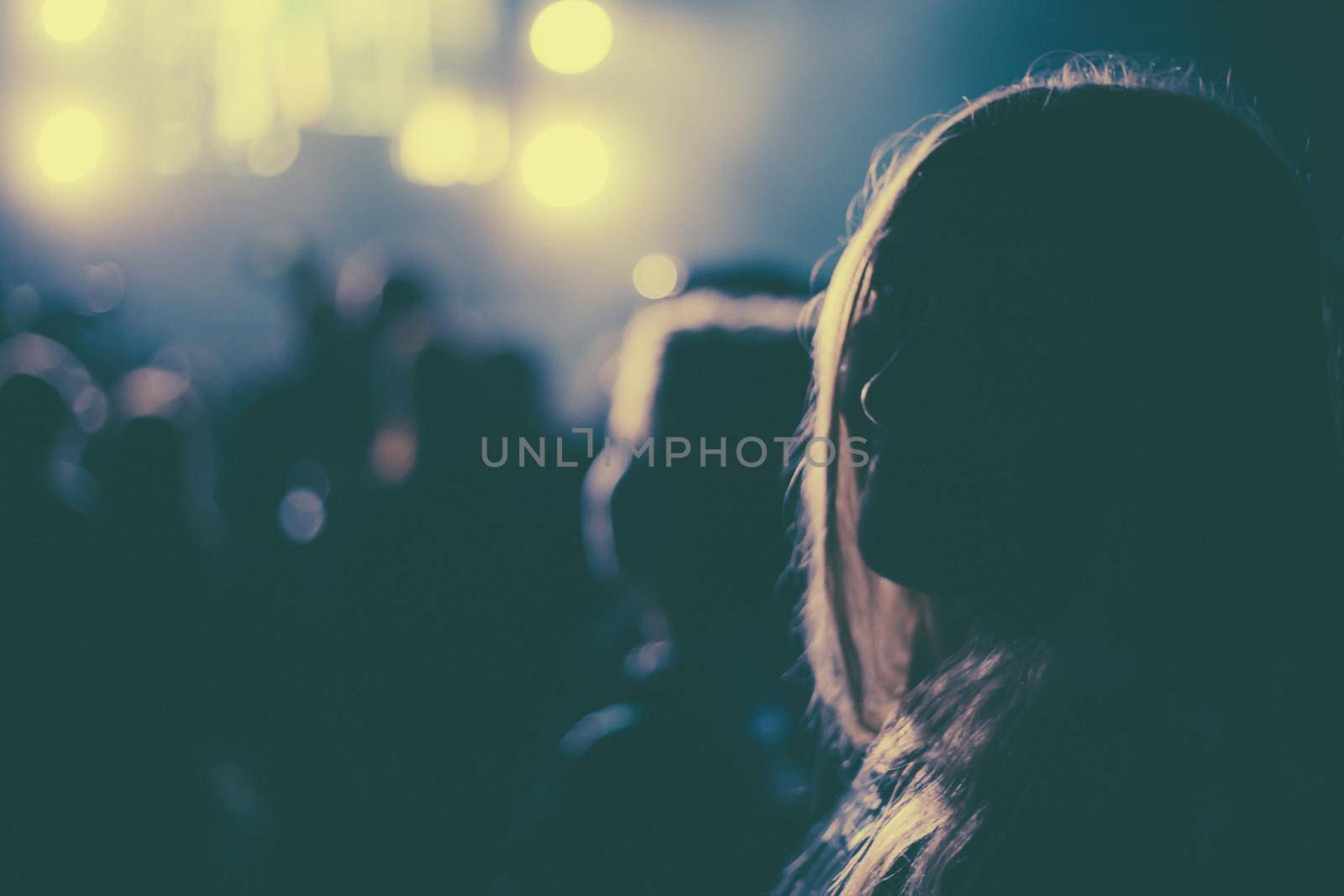 silhouettes of a girl on a New Year's holiday in neon light, blurred background