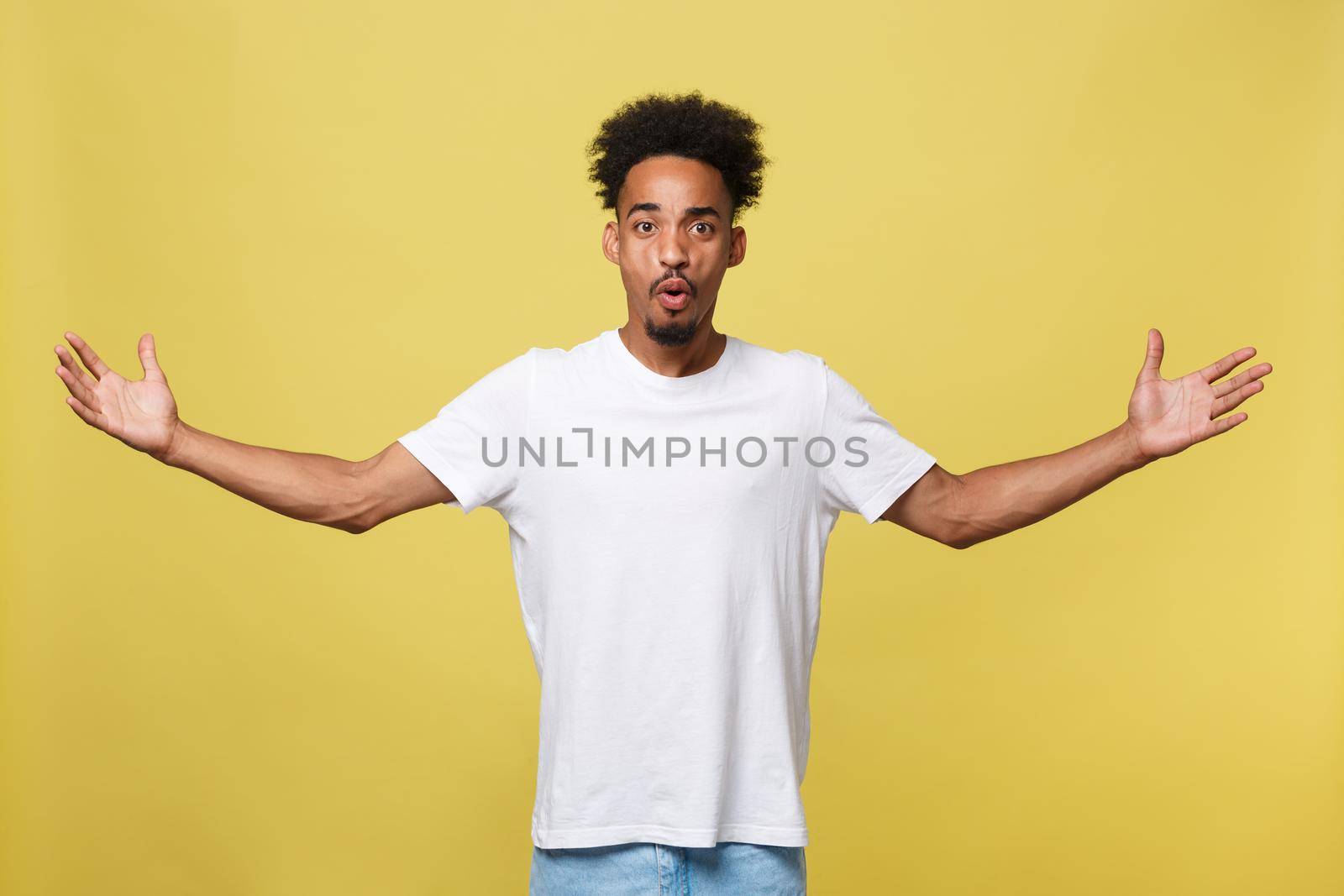 Advertising concept. Portrait of handsome African entrepreneur or office worker wearing suit pointing his finger at yellow studio wall with copy space for your content, looking shocked and surprised. by Benzoix