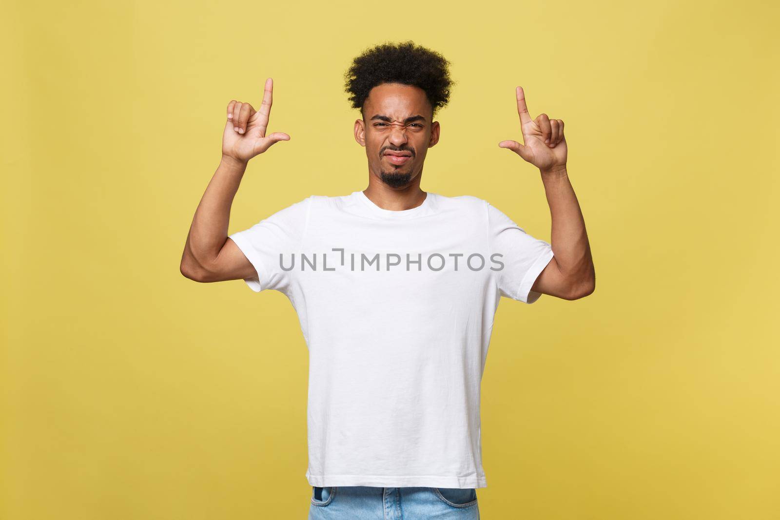 serious dark-skinned African American young man shows a finger upwards.