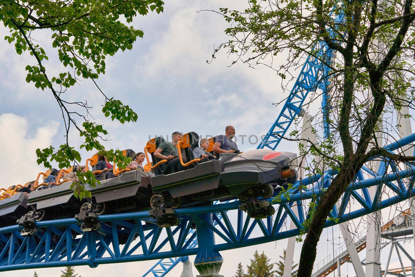 Saint Petersburg, Russia - June 12, 2021: People ride attractions in the city park in St. Petersburg