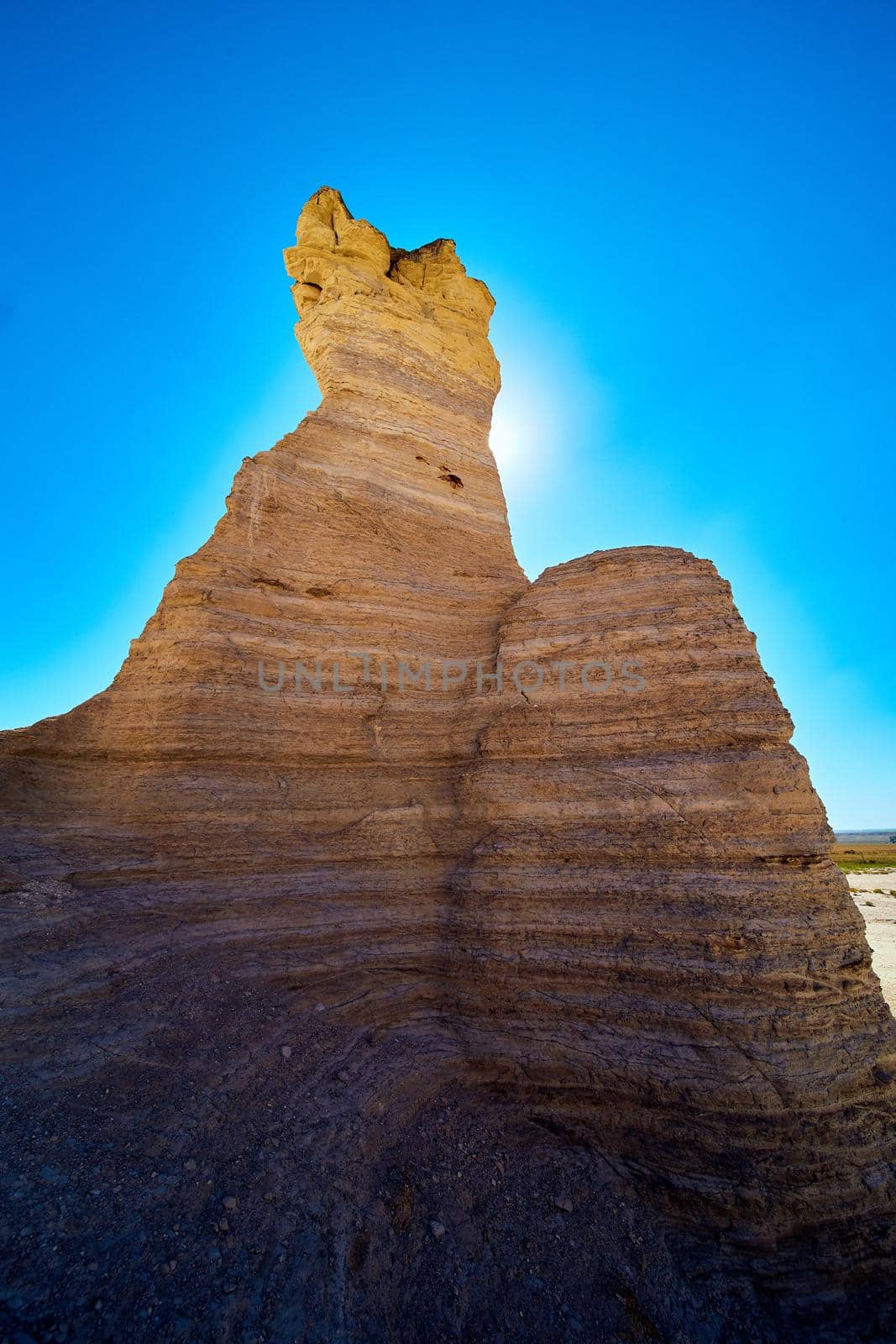 Image of Sun blocked by large pillars of rock in desert