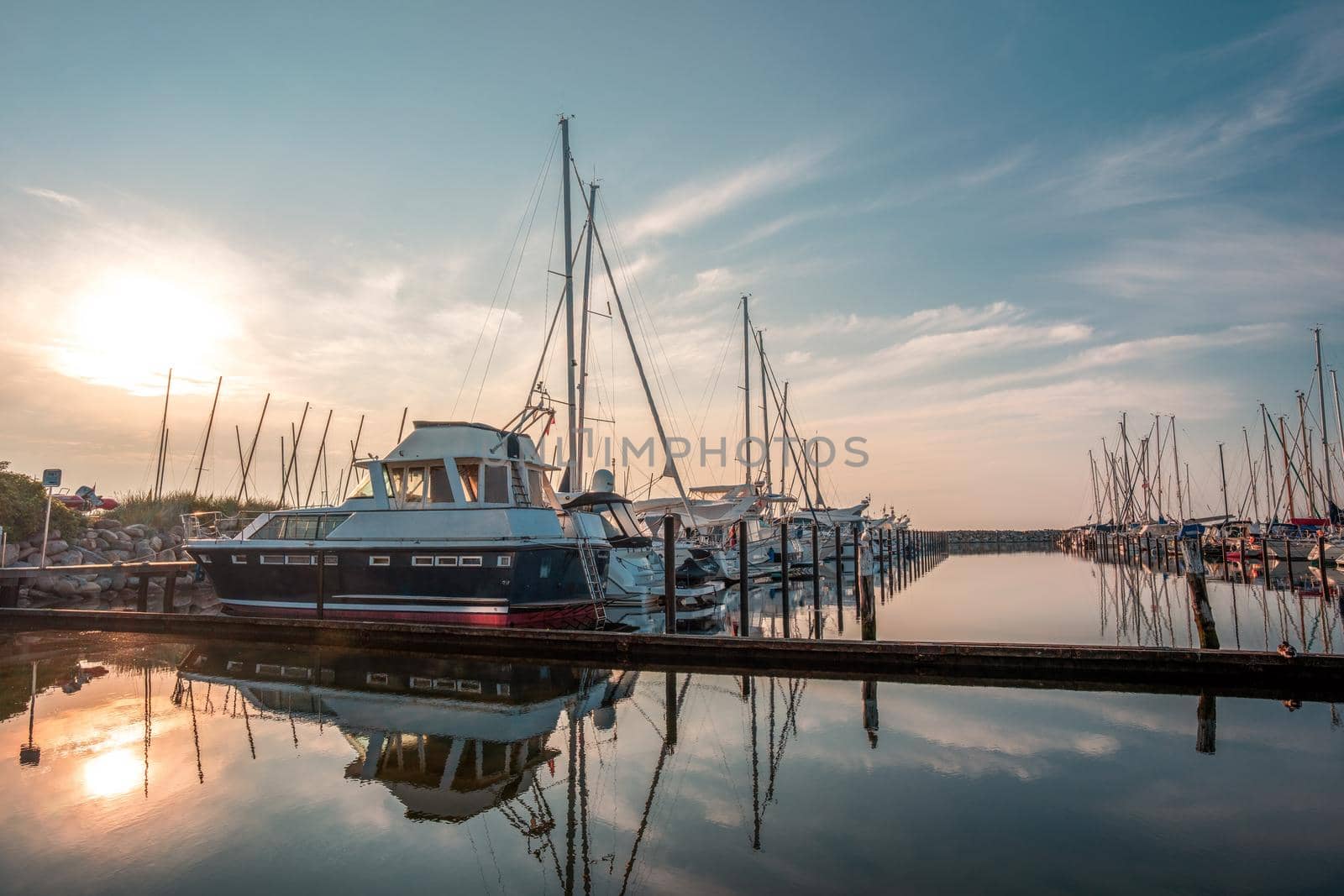 Boat jetty with yachts on a pier in the morning