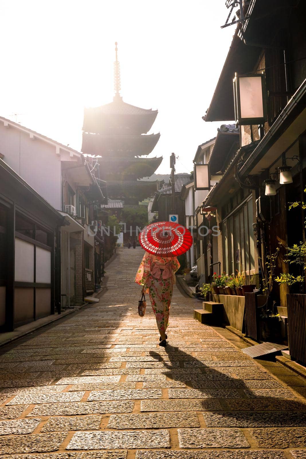 Japanese girl in Yukata with red umbrella in old town  Kyoto, Japan
