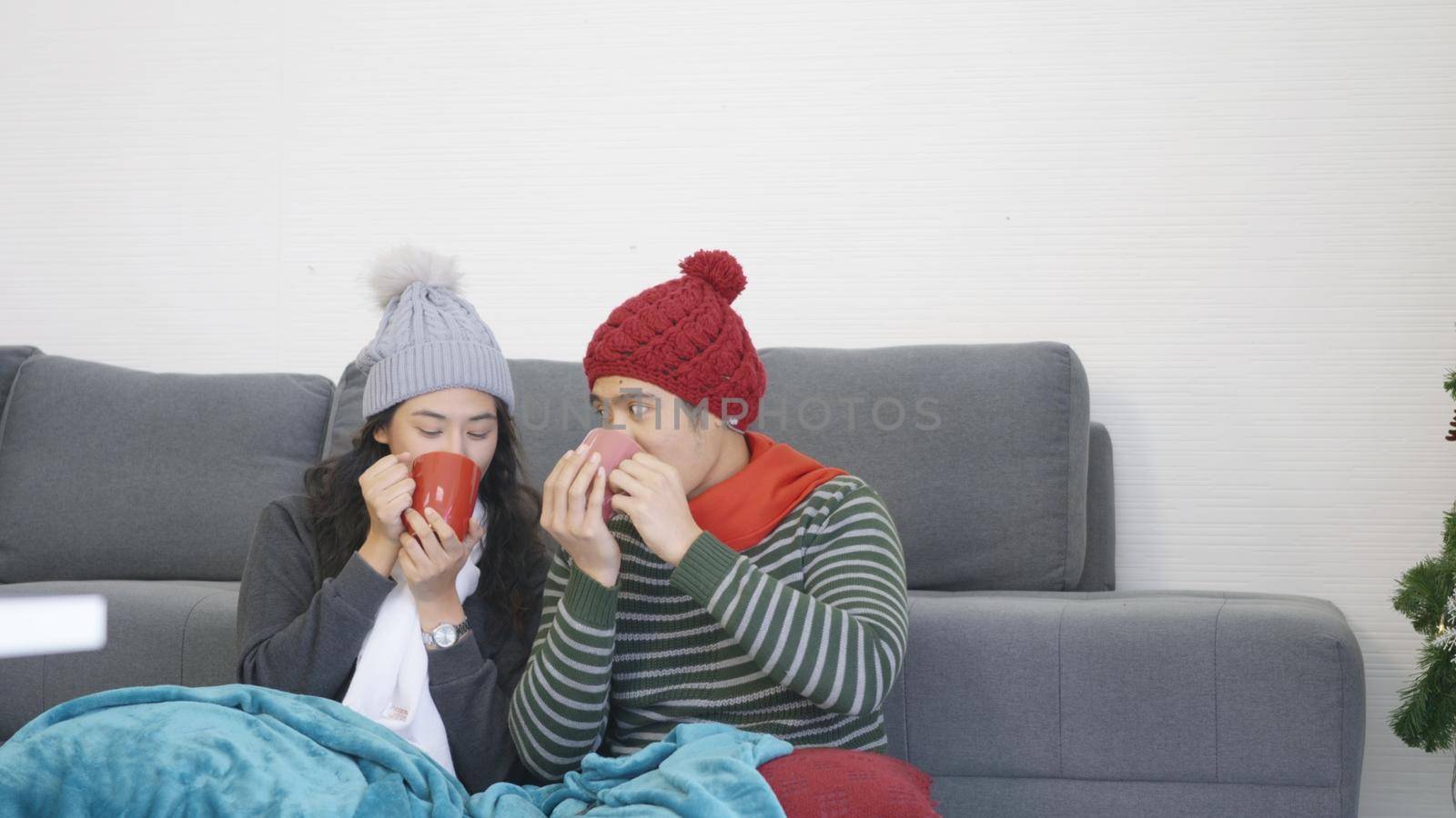 couple husband and wife smile relaxing. drinking tea in winter holiday by Sorapop