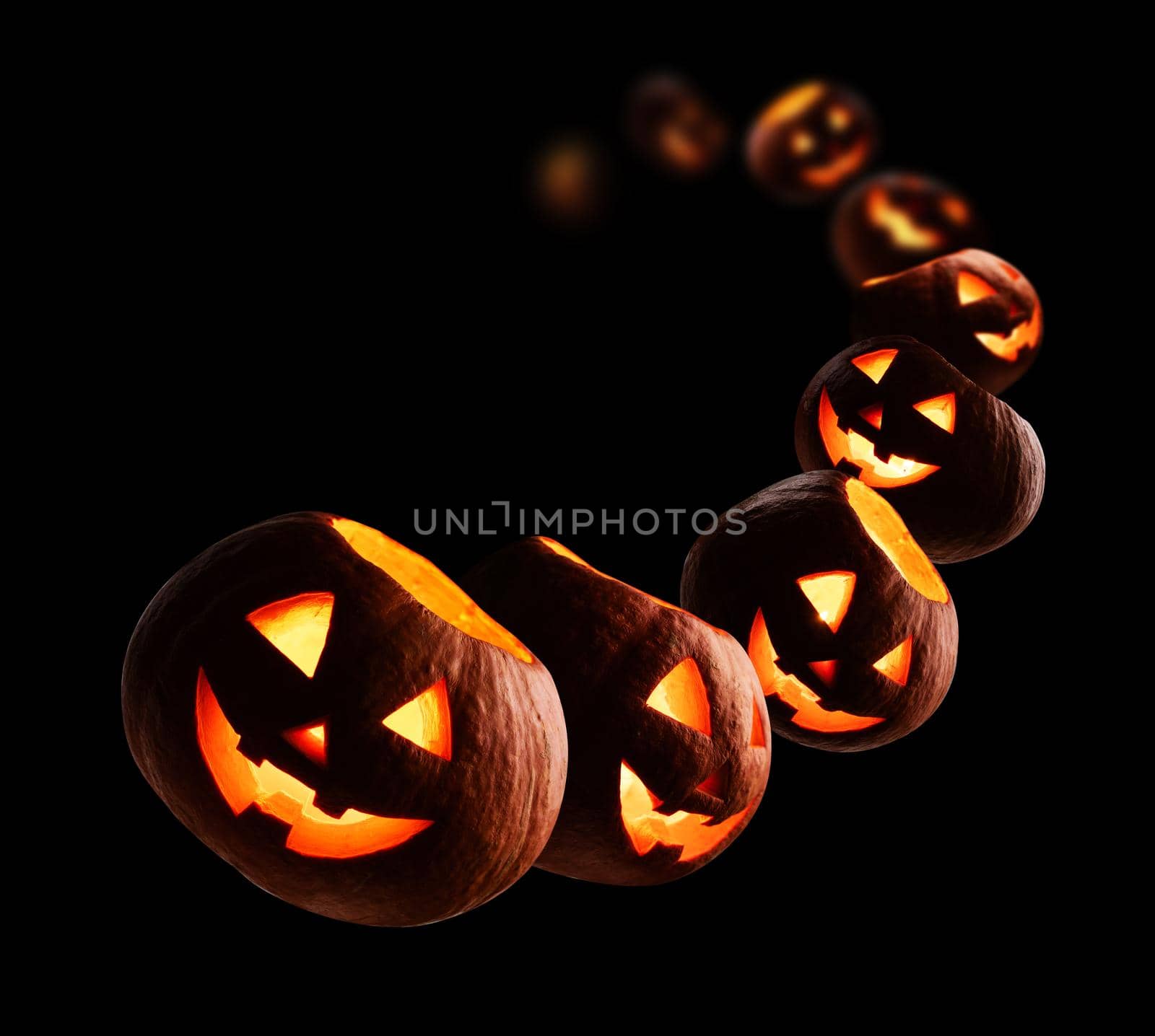 Glowing pumpkins levitate on a black background.
