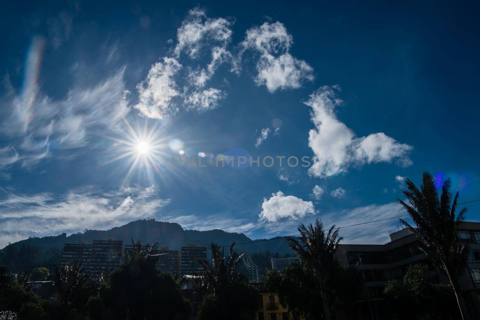 Mount Monserrate with sun star in the sky. by jyurinko