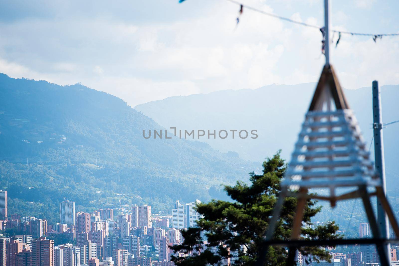 Rolling hills of Bogota Colombia with triangular tower in the foreground by jyurinko