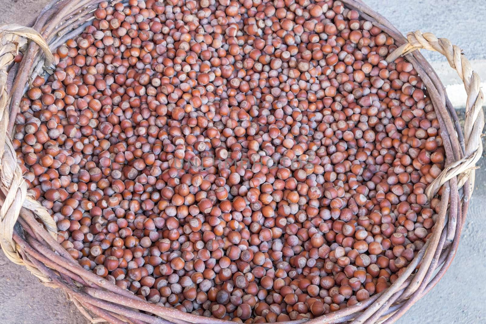 hazelnuts in a large wicker basket close-up by roman112007