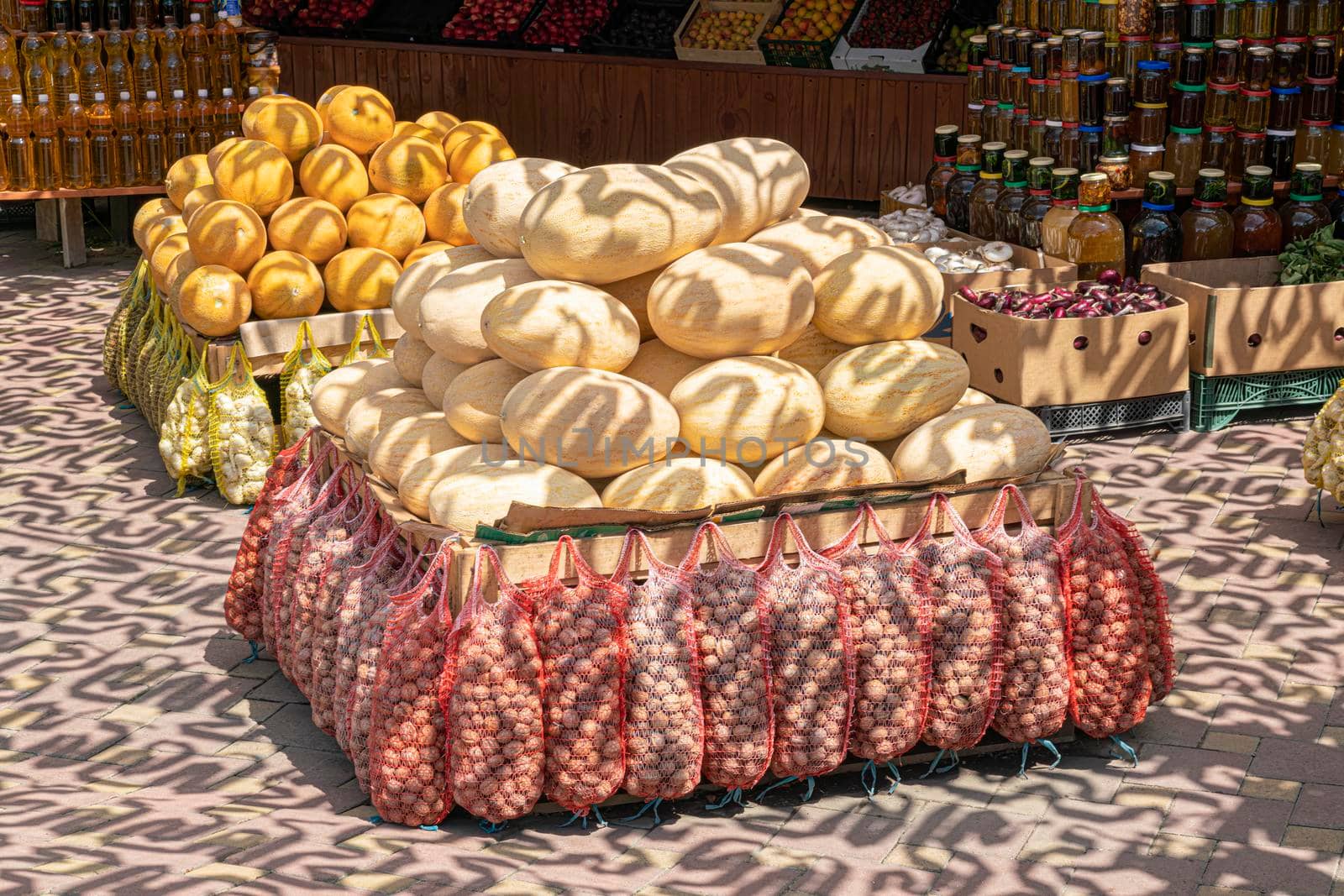 A bunch of fresh ripe melons at the market by roman112007