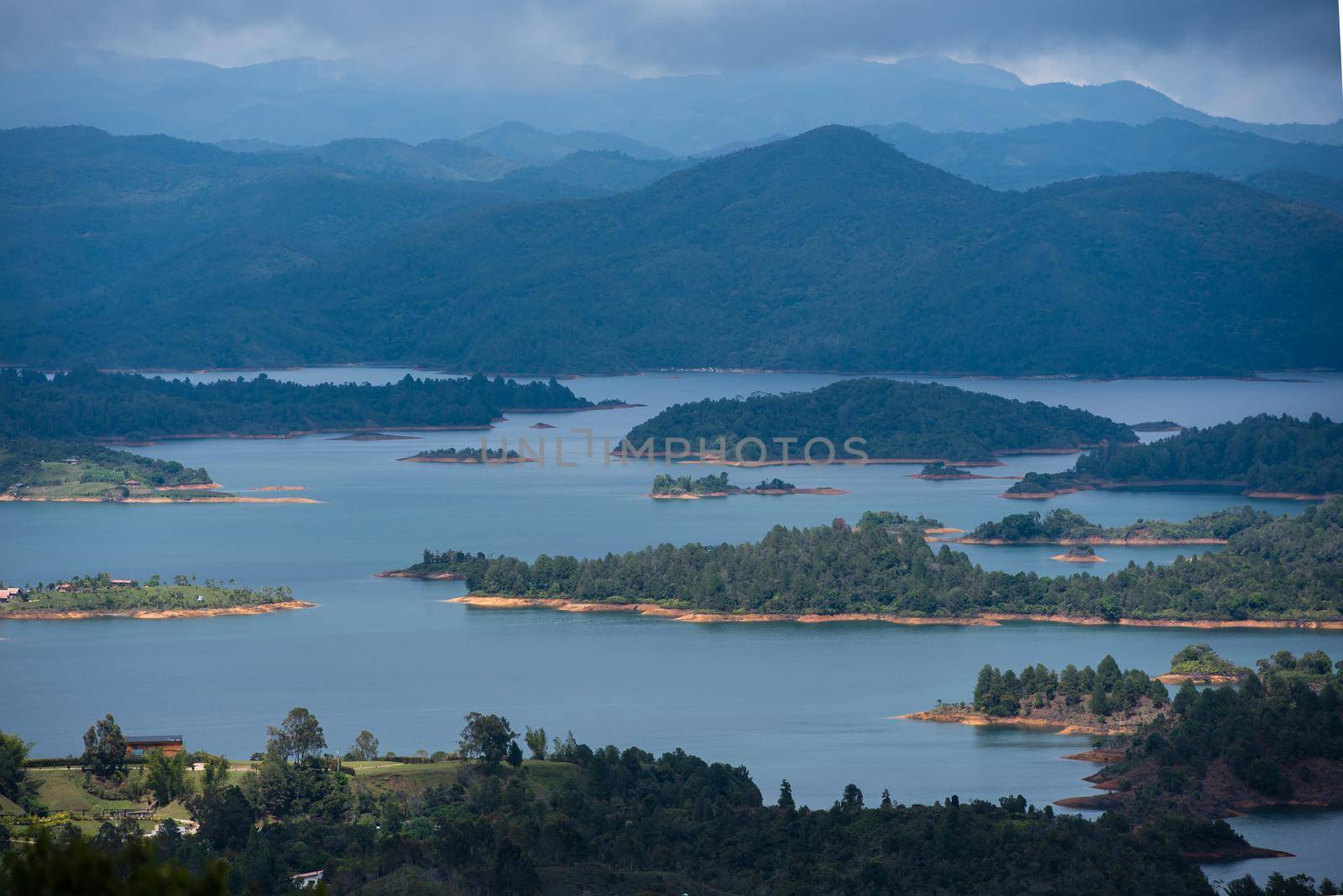 View at the top of El Penon de Guatape looking out at layers of beautiful land water and terrain.