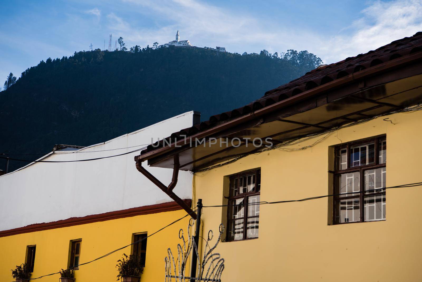 Mount Monserrate Colombia with yellow buildings in the foreground creating geometric shapes