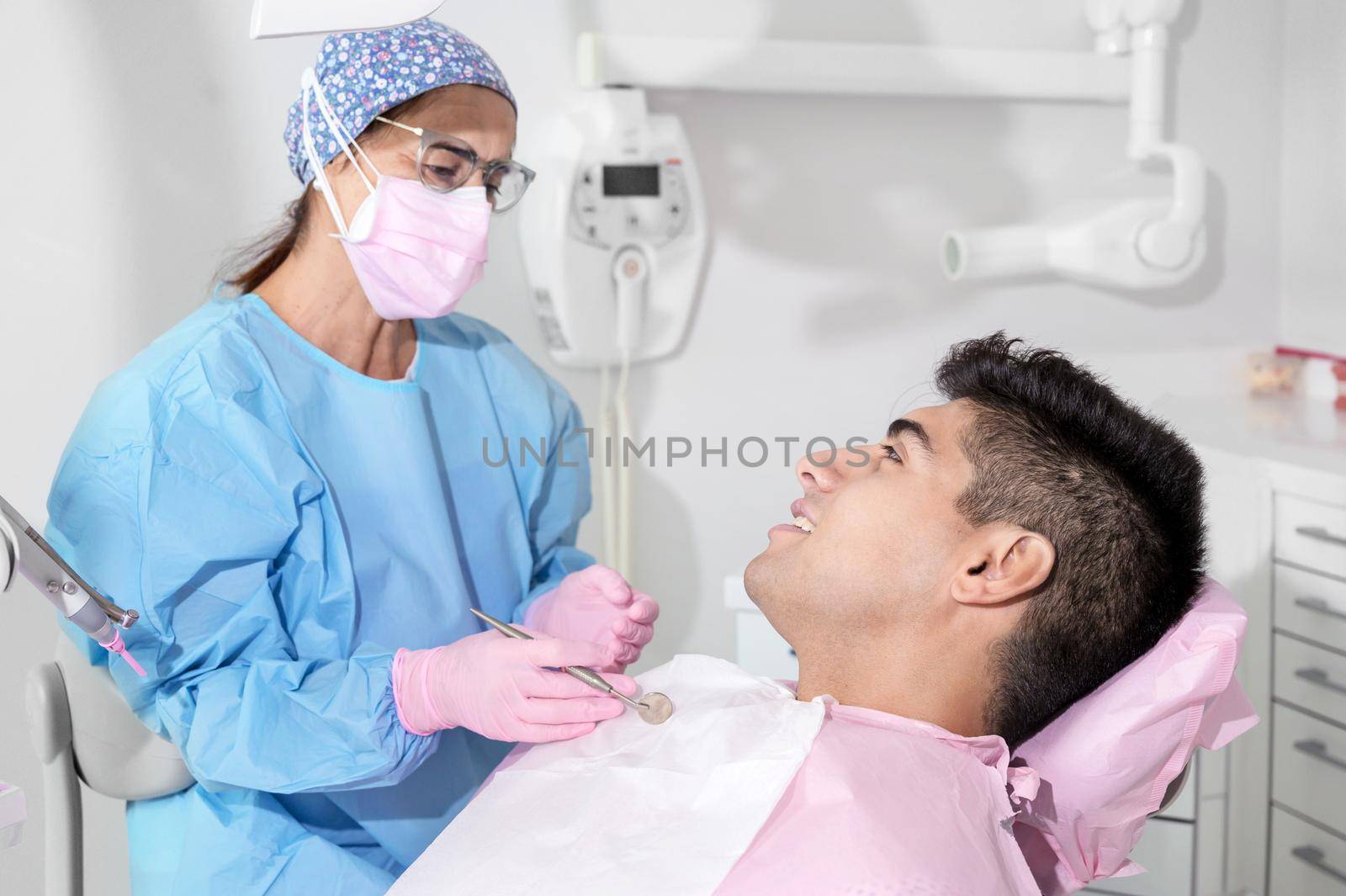 Doctor treats patient teeth in modern dental clinic. High quality photo