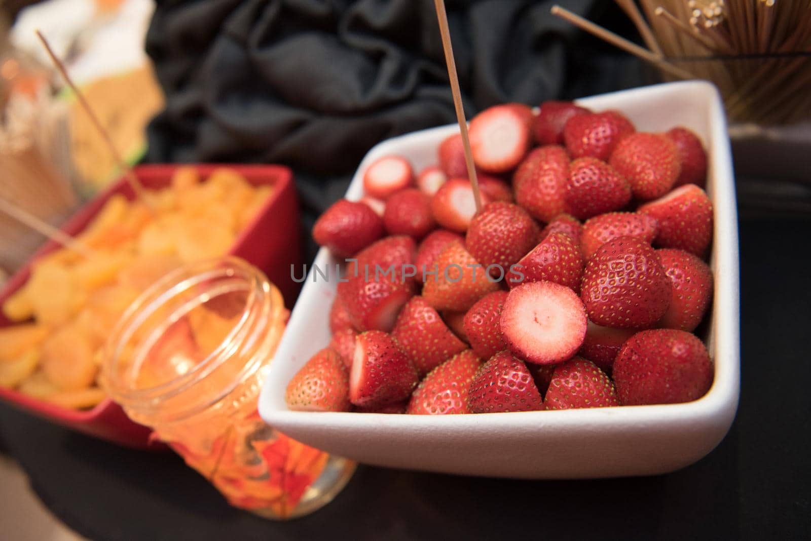 Strawberries in a white square serving bowl fruit tray