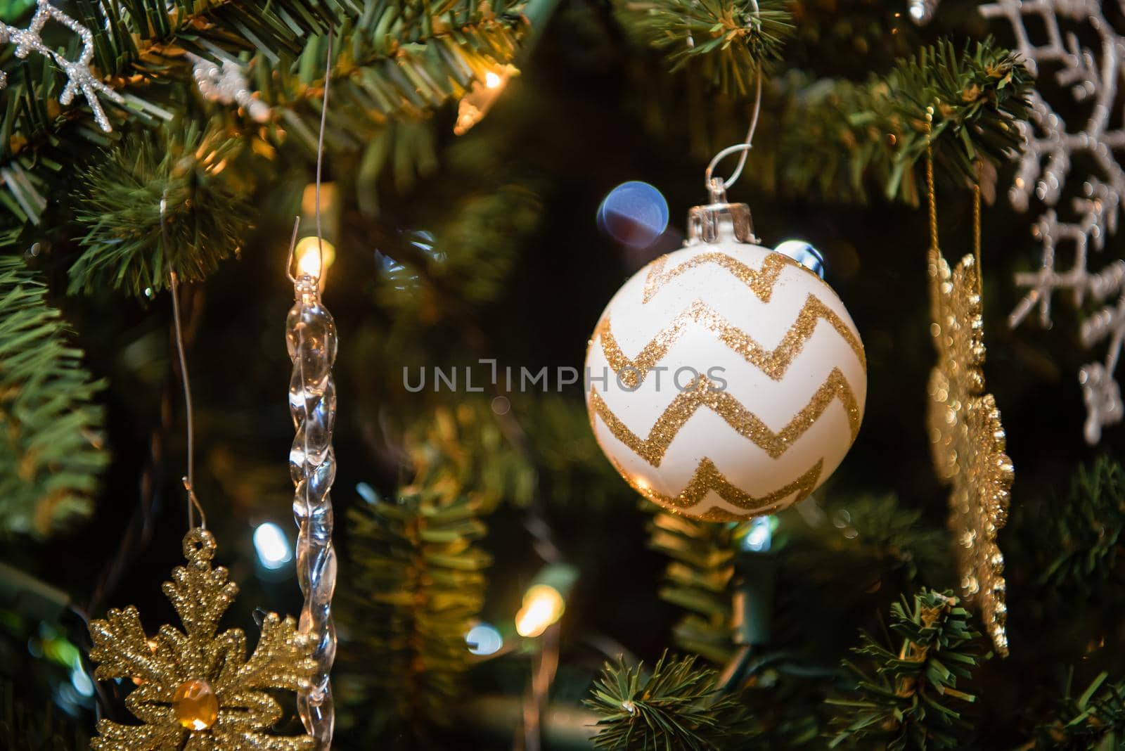 Christmas tree ornaments with gold and white glitter bulb. Close up by jyurinko