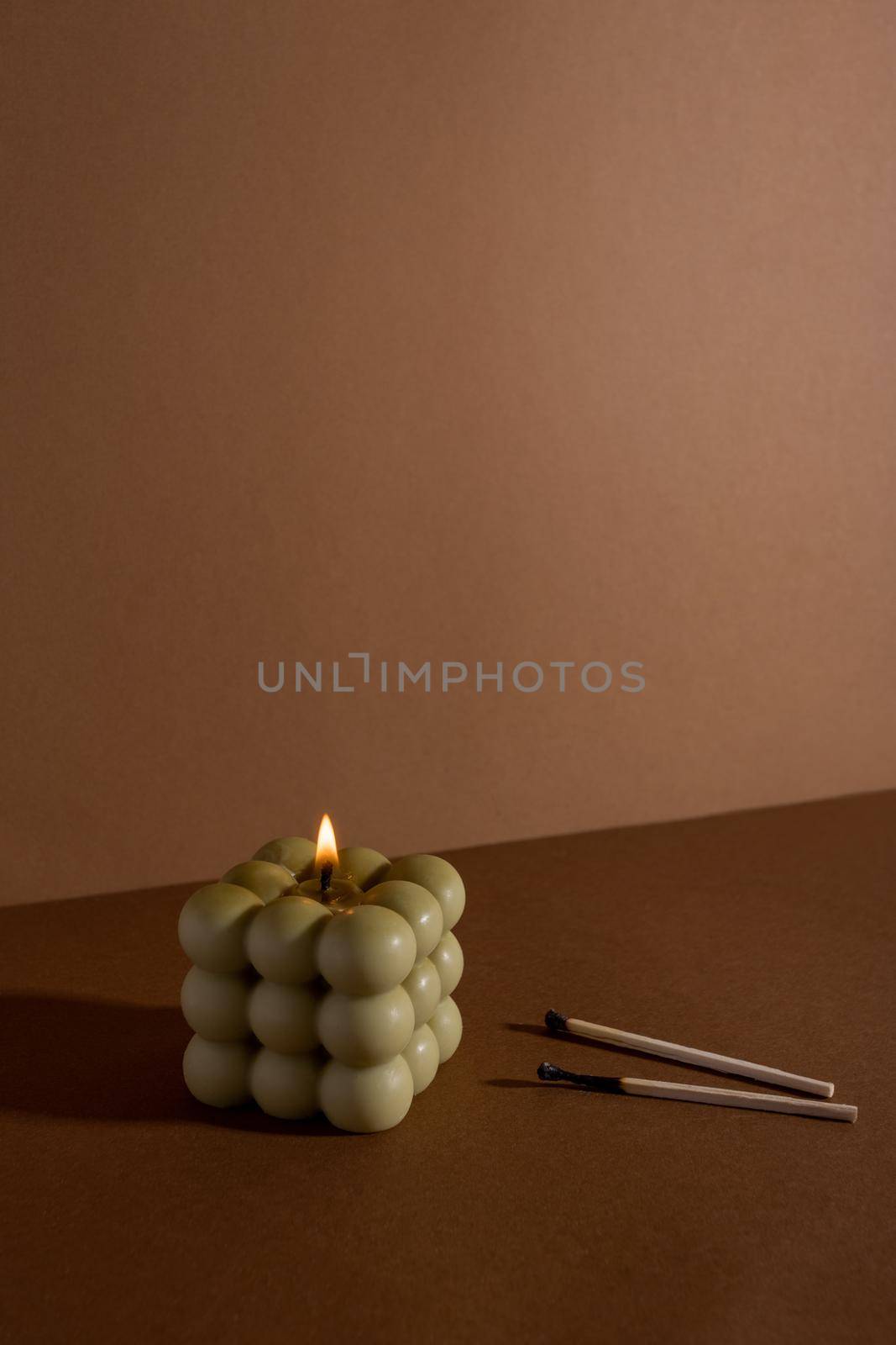 Aromatic scented soy candle with smoke on beige brown textile background , modern bubble candle still life by katrinaera