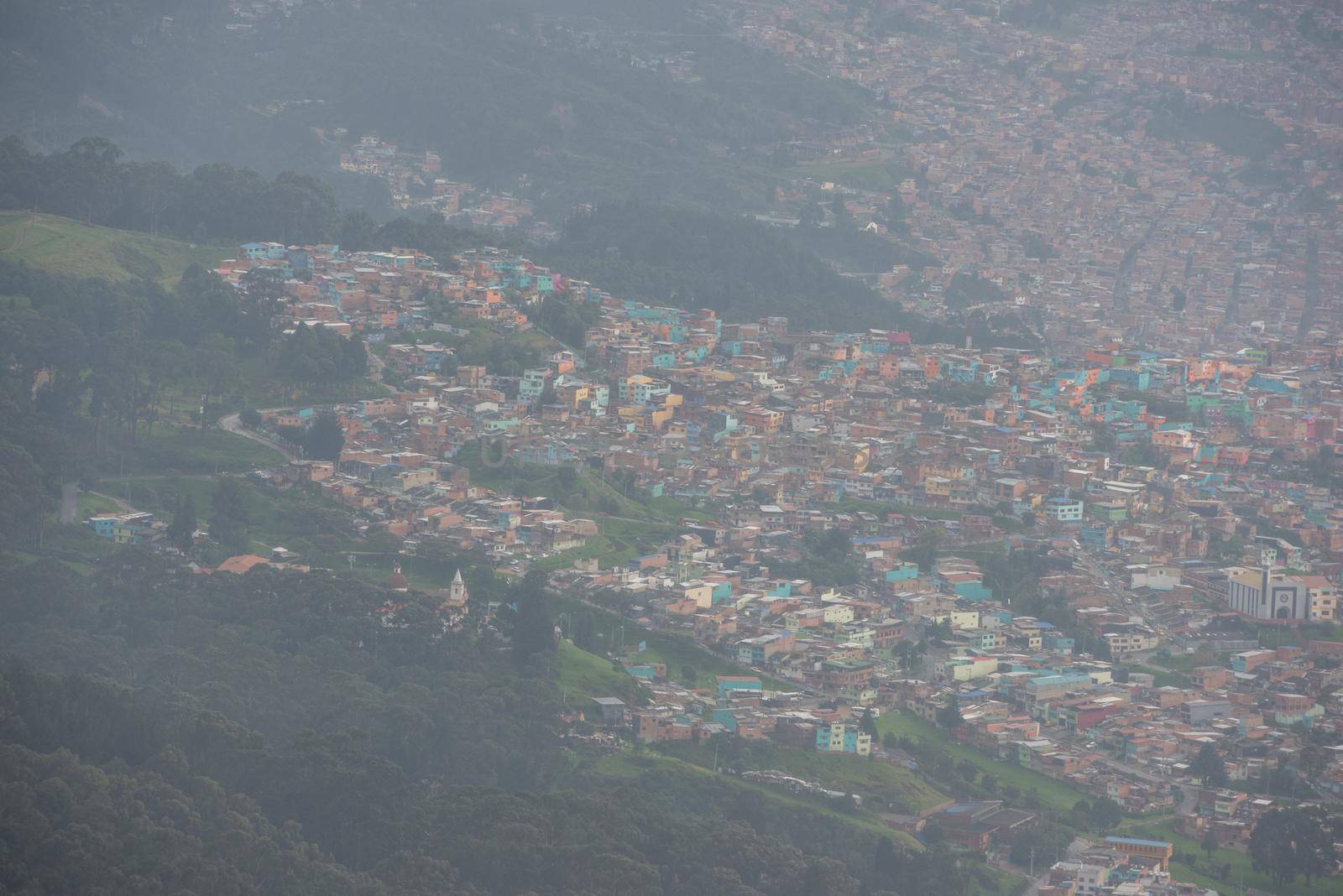 View of many pastel homes from the top of Mount Montserrate in Bogota Colombia.