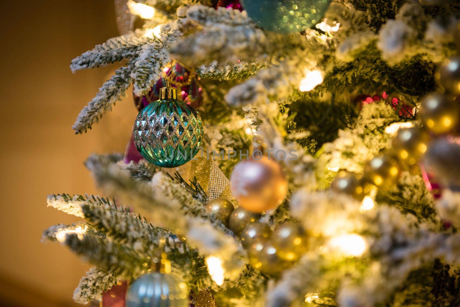 Christmas tree ornaments with gold and green bulbs. Close up by jyurinko