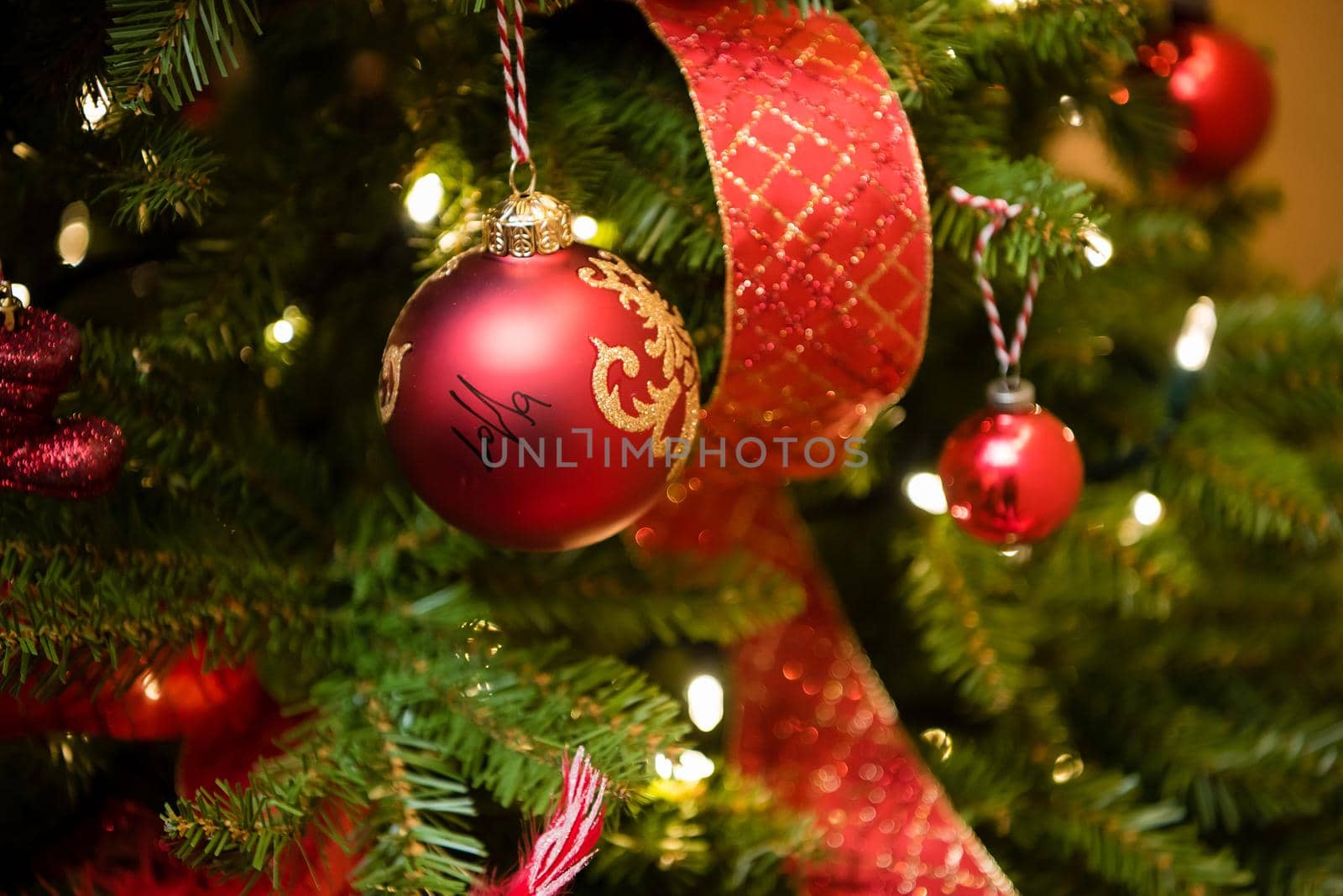 Christmas tree red ornaments and ribbbon. Close up by jyurinko