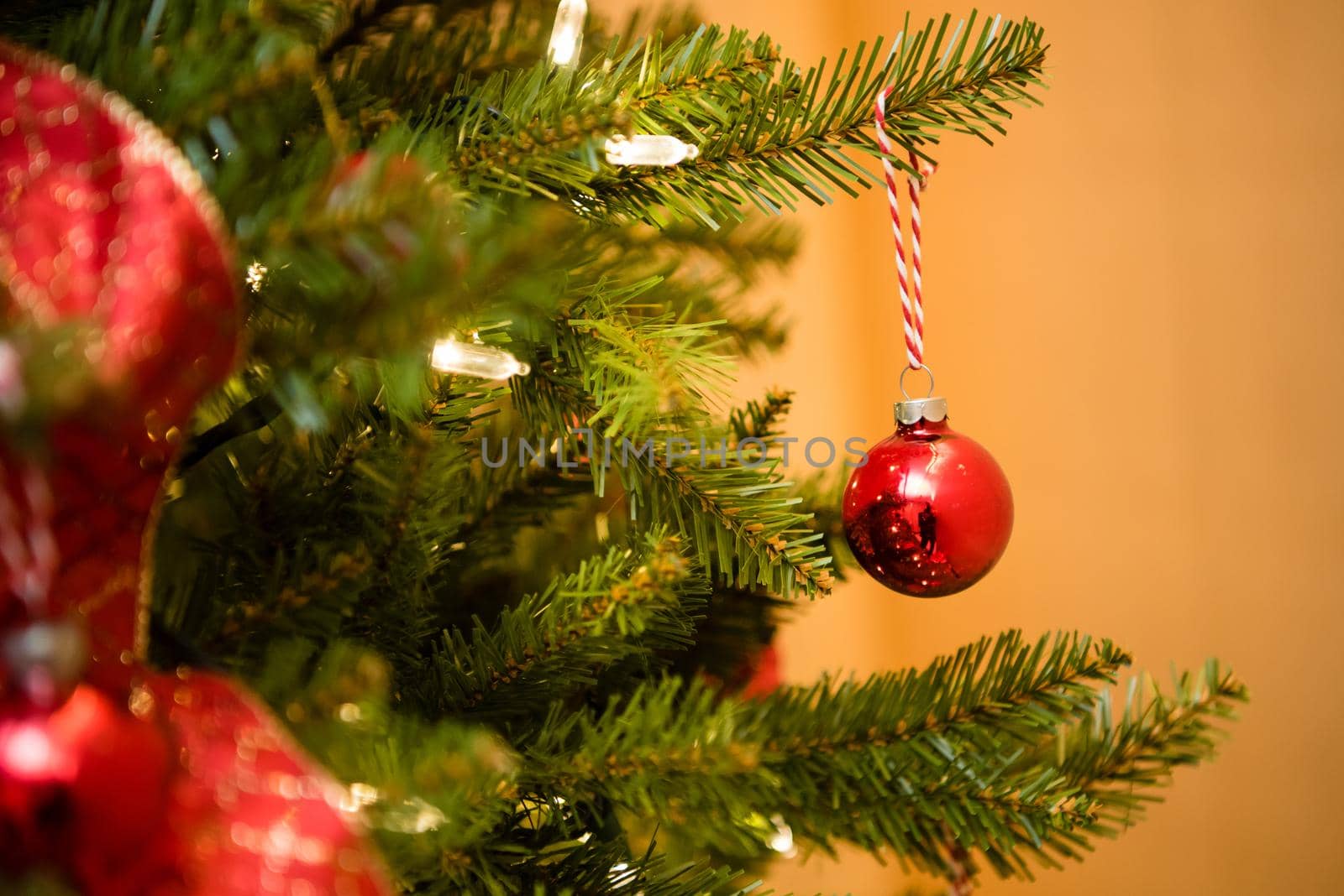 Christmas tree red ornaments and ribbbon. Close up by jyurinko