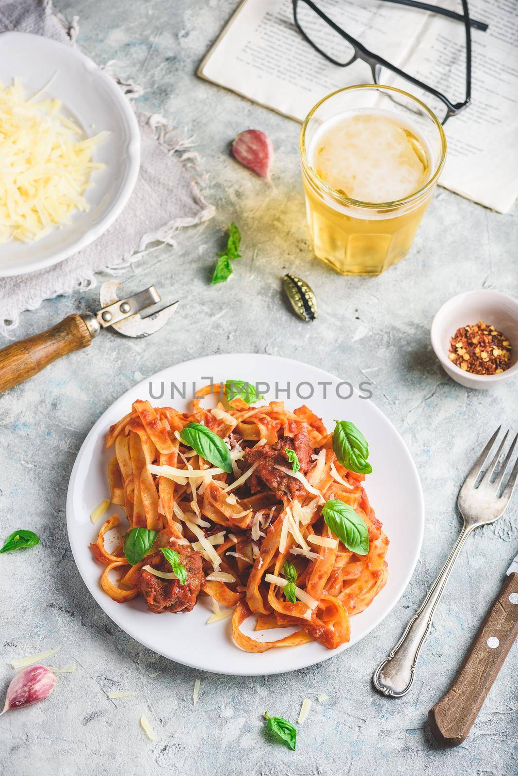 Pasta with mini meatballs, tomato sauce and parmesan cheese. High angle view