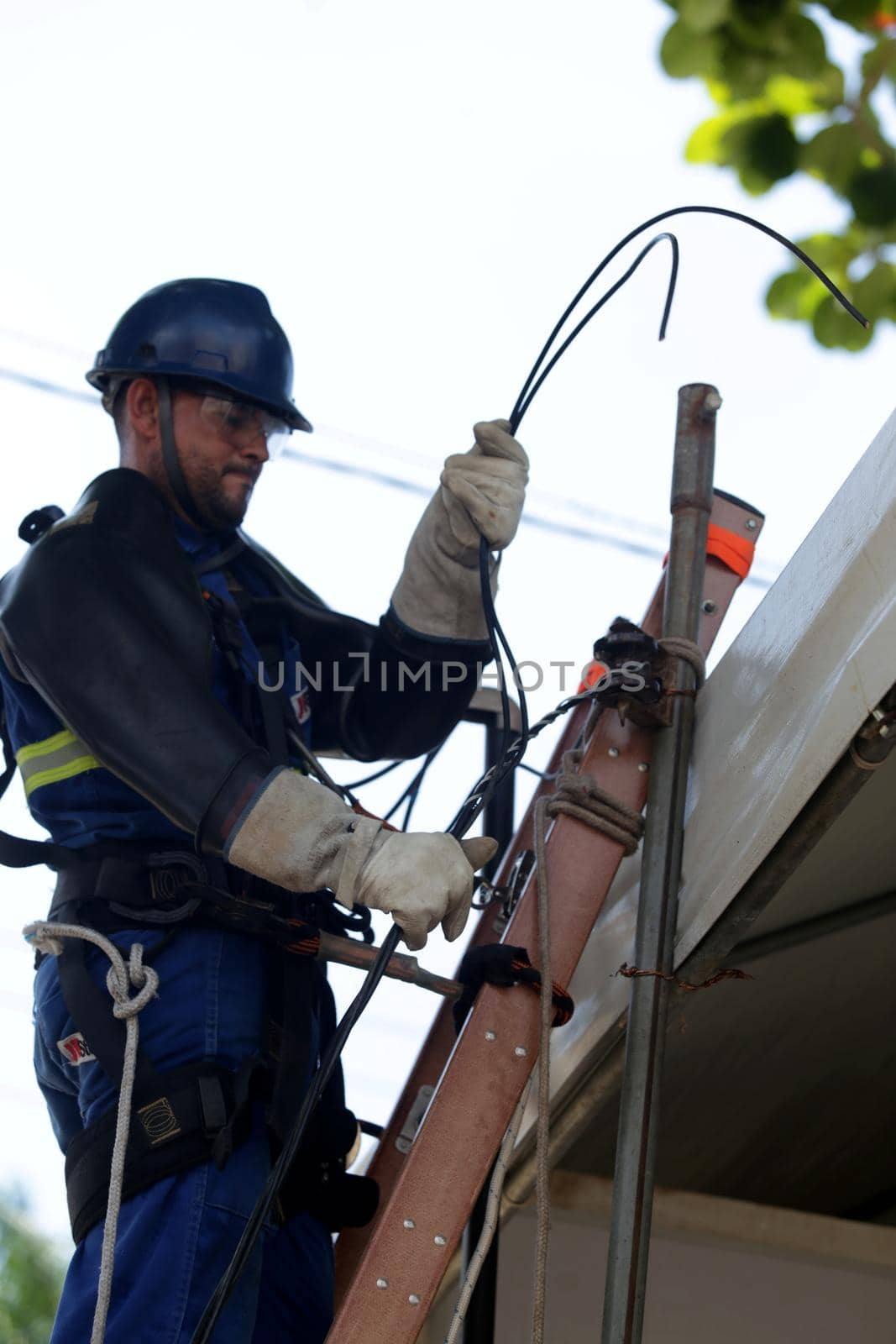 salvador, bahia, brazil - february 28, 2019: Electrician works on temporary connection in electrical network in Salvador city.