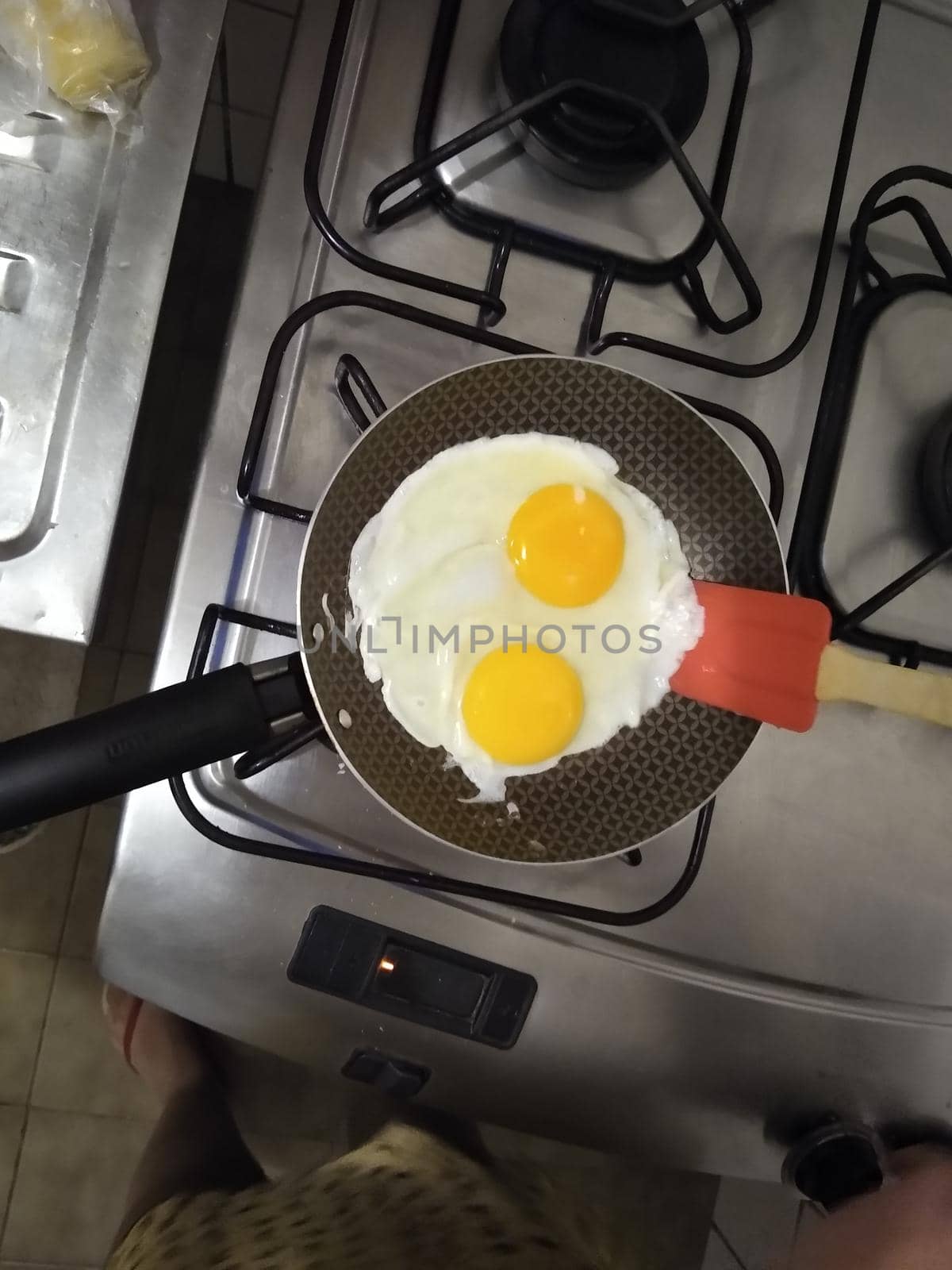 salvador, bahia, brazil - july 18, 2021: Fried eggs are seen in a frying pan on a stove in the kitchen of a house in Salvador city.