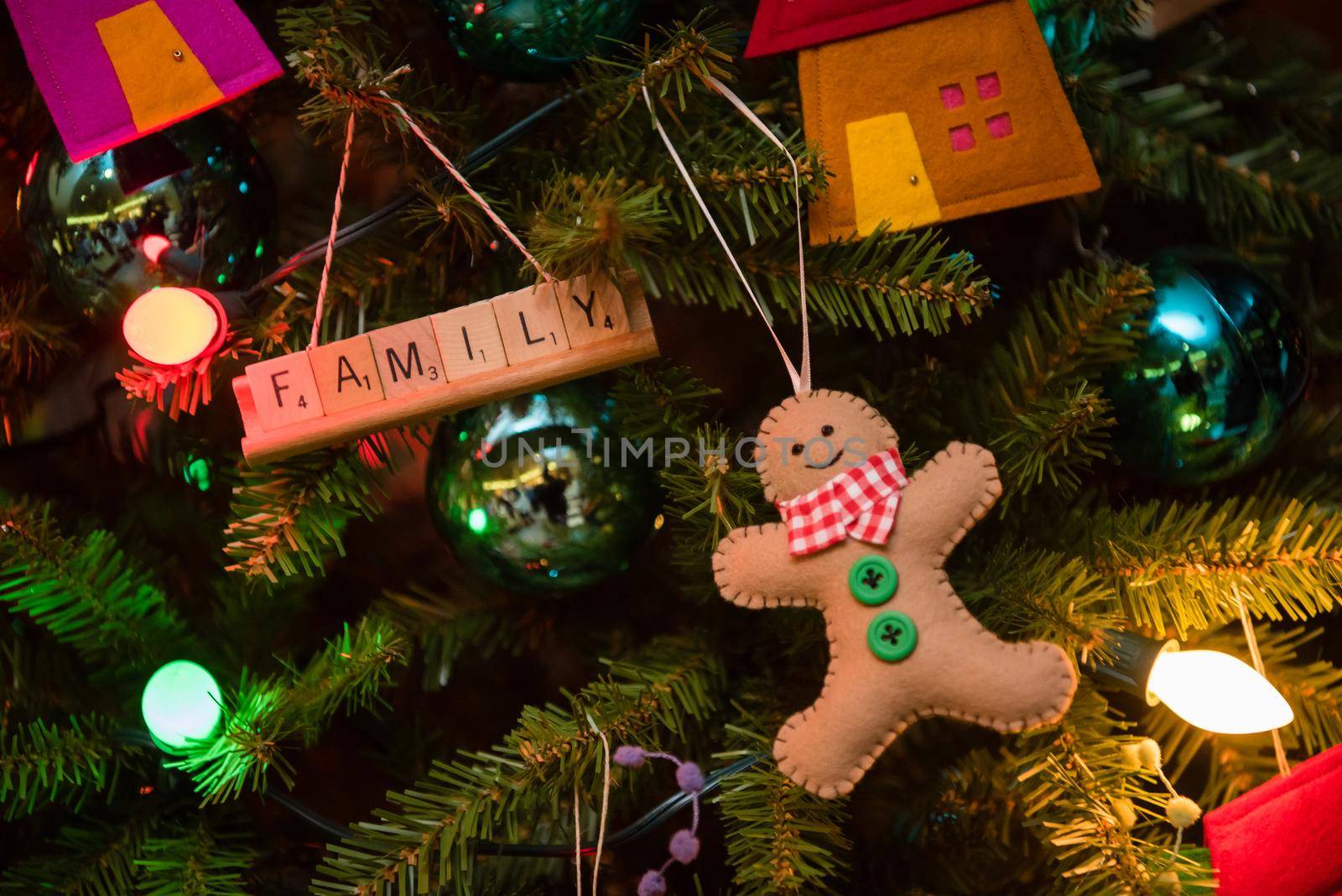 Christmas tree with gingerbread man snowflake houses and Family decoration. by jyurinko