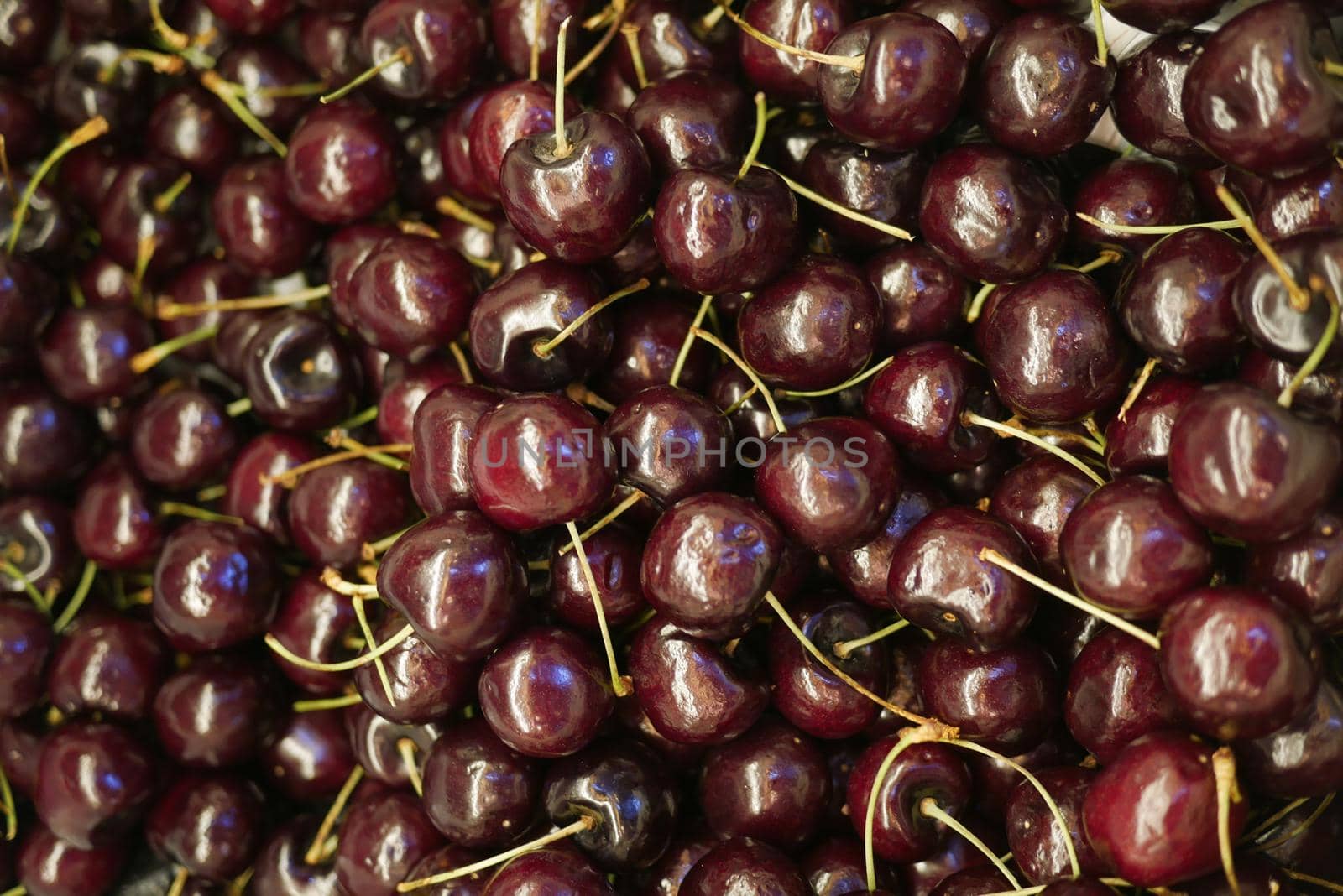 close up of cherry fruit display for sale at local store .
