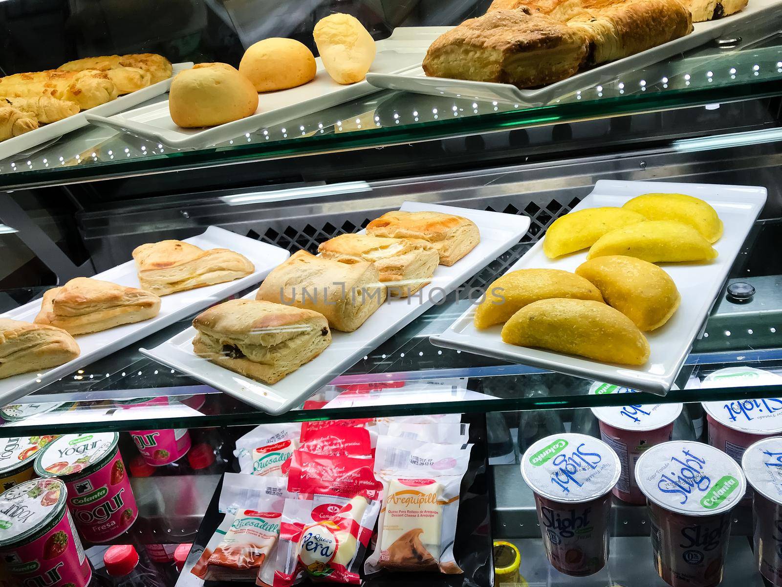 Empanadas and croissants in Colombian bakery. Fresh baked goods
