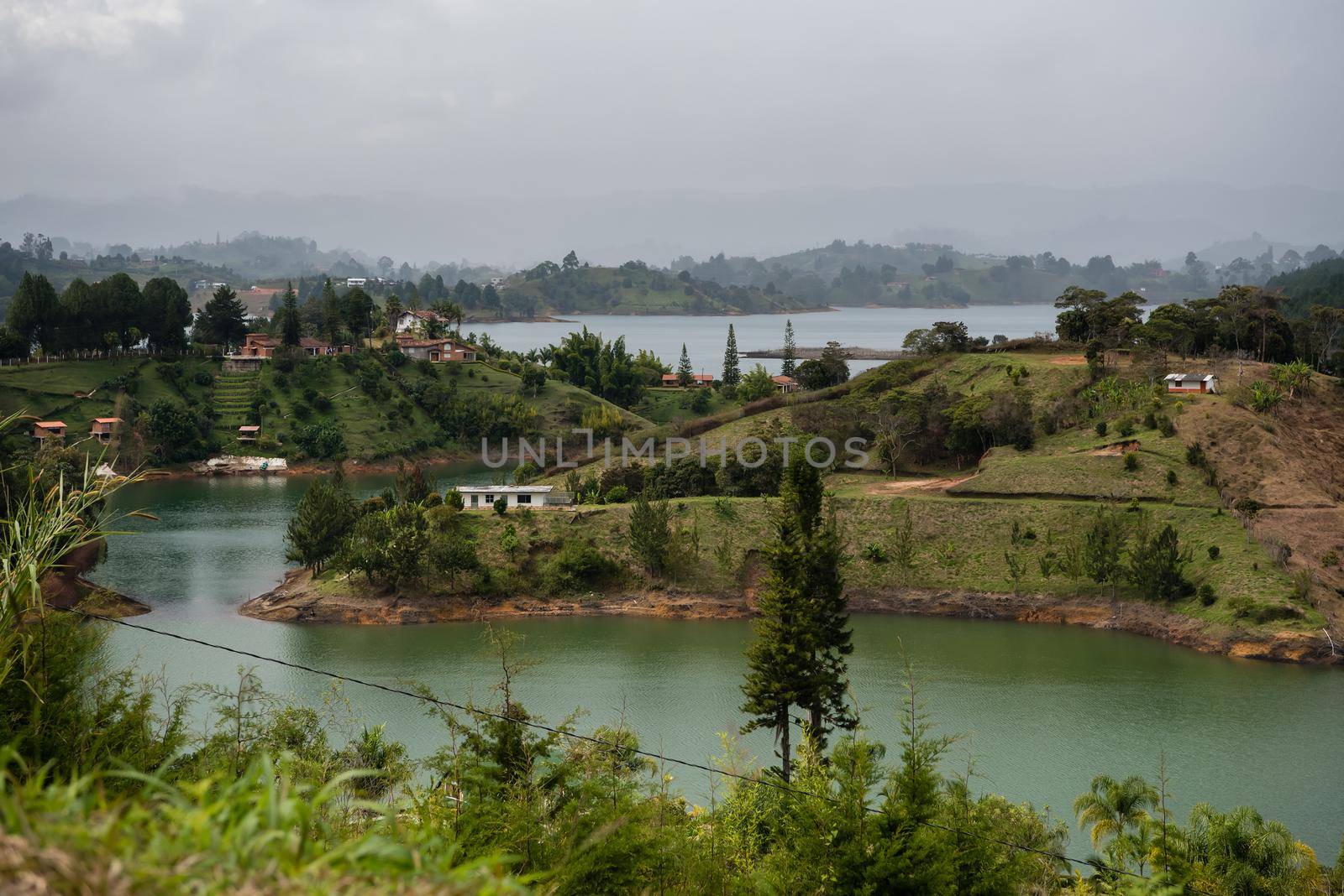 Climbing El Penon de Guatape looking down at tropical waters by jyurinko