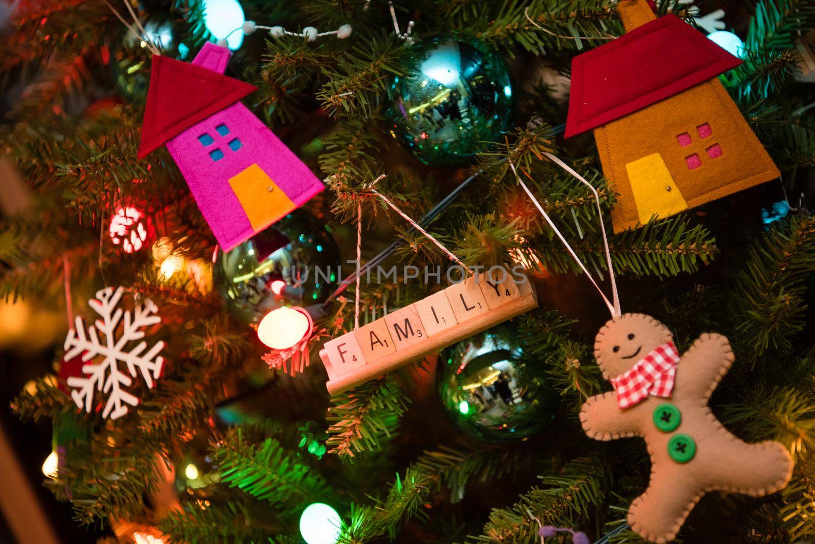 Christmas tree with gingerbread man snowflake houses and Family decoration. by jyurinko