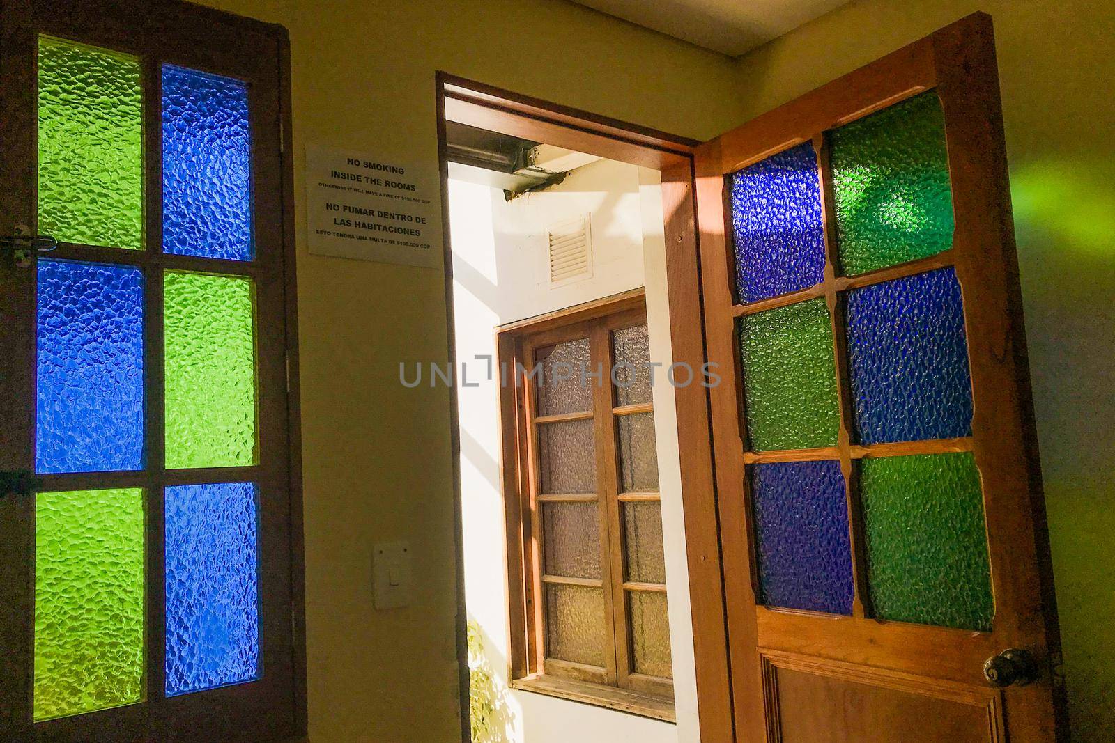 Green and blue stained glass windows from hostel in Colombia.