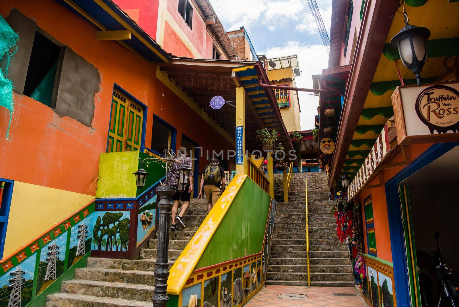 View of staircase in downtown Guatape, Colombia with colorful patterns on the buildings.