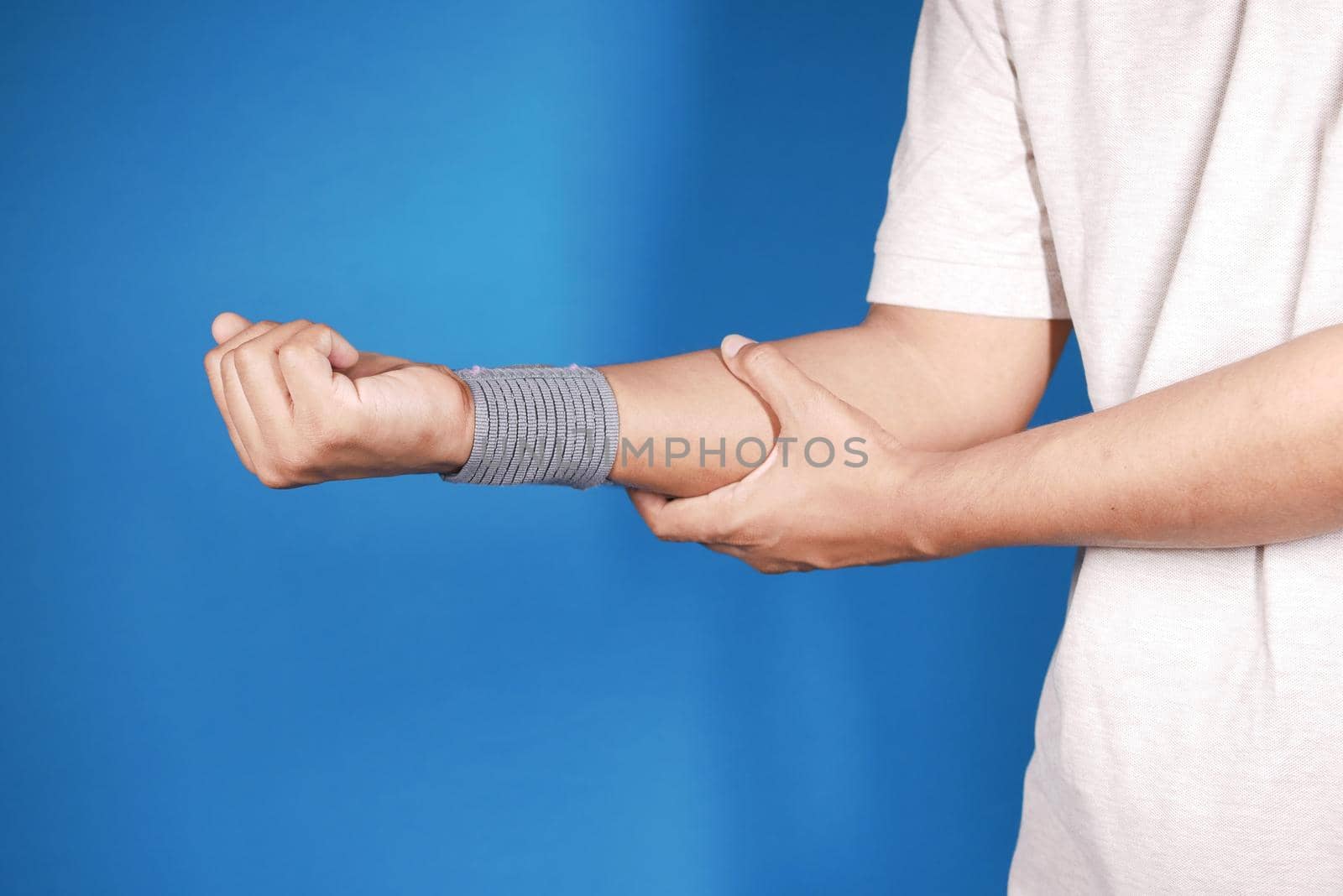 hand with wrist support against blue background