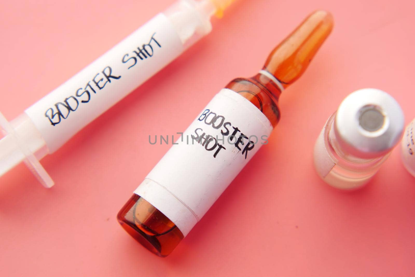 booster shot dose coronavirus vaccine and syringe pink .