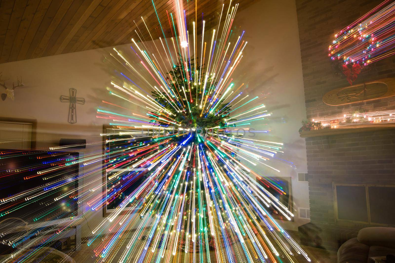 Large decorated Christmas tree inside of living room with light streaks