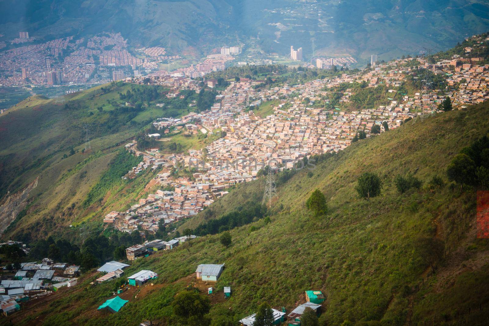Aerial view of many houses over rolling hills in Medellin, Colombia. by jyurinko