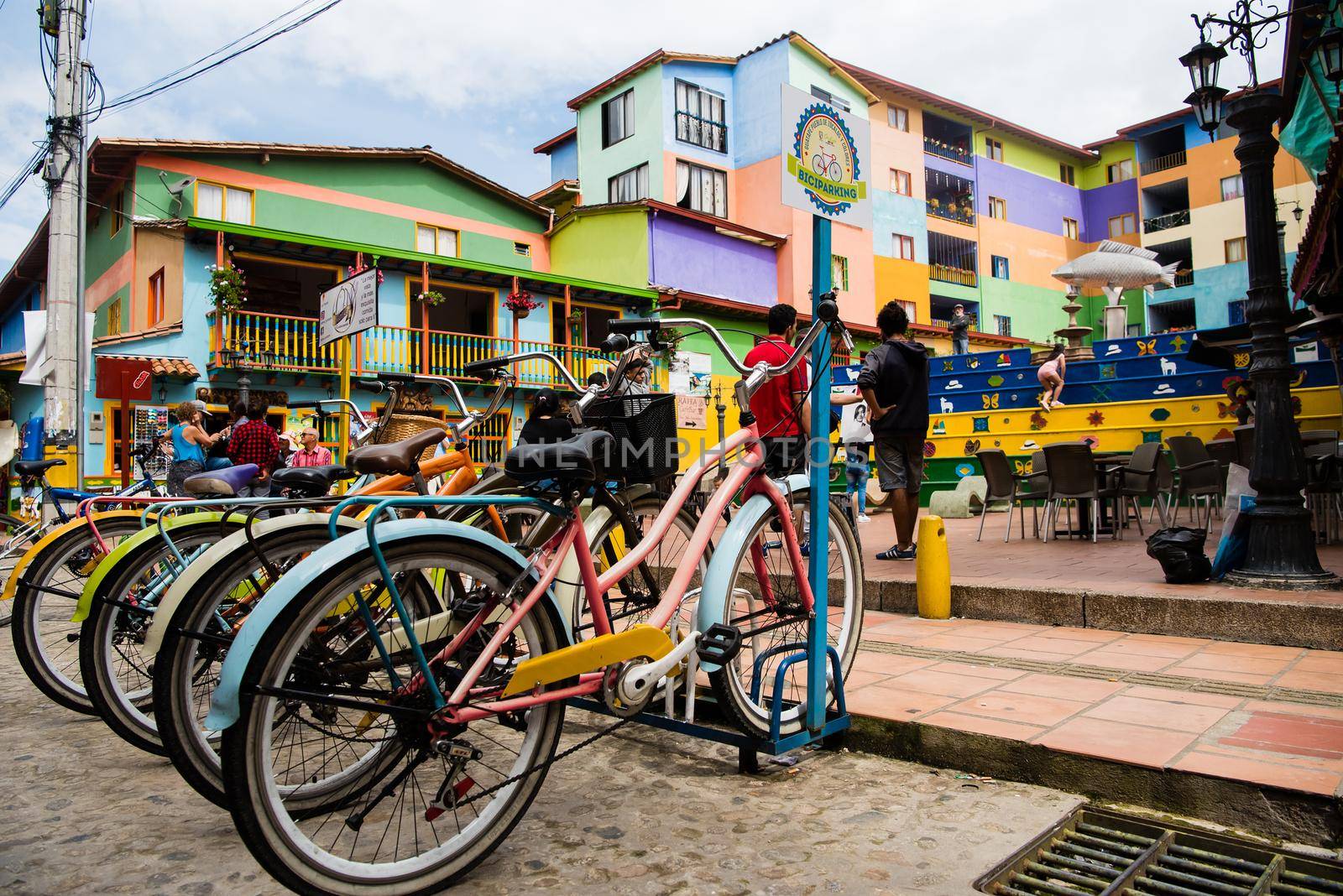 View of downtown Guatape, Colombia with colorful pastel bicycles and architecture.