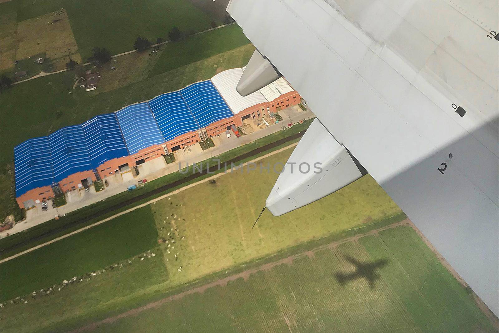 Aerial looking down airplane shadow. by jyurinko