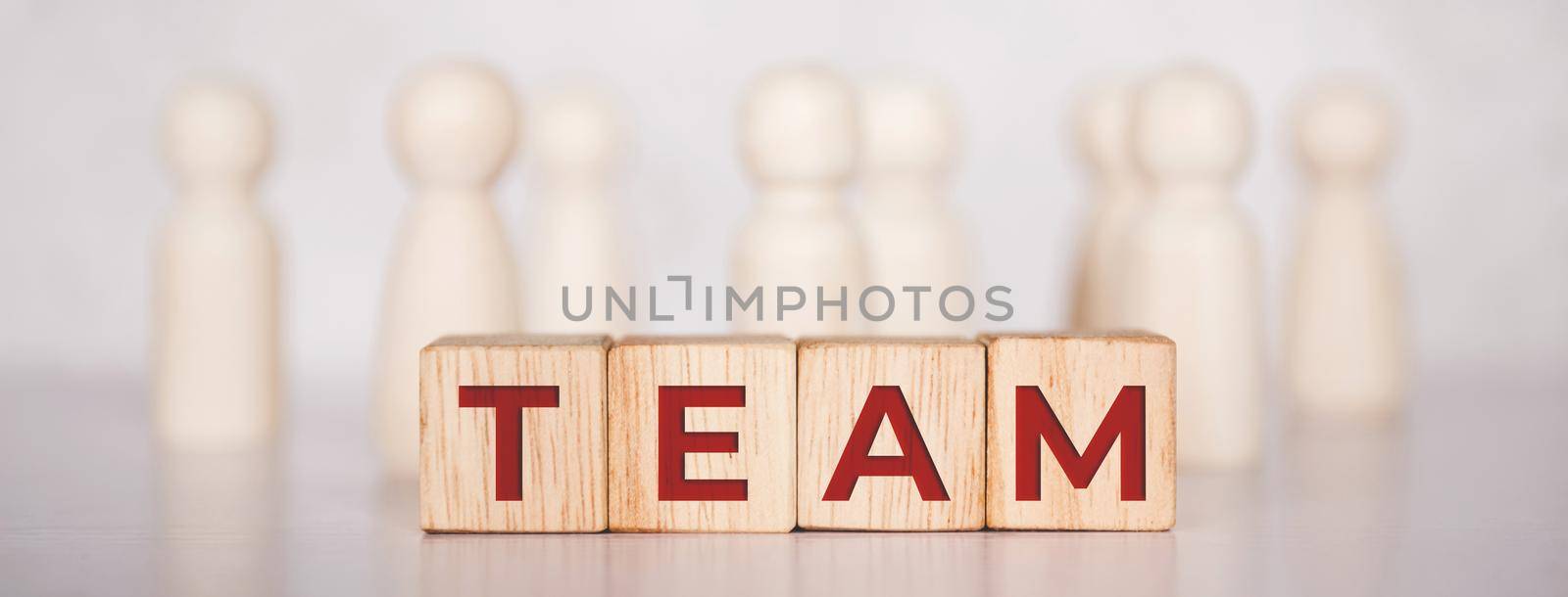 Word team on wooden block, relationship of collaboration and leadership for success, group of community and employee with corporate, teamwork for brainstorming together, no people, business concepts.