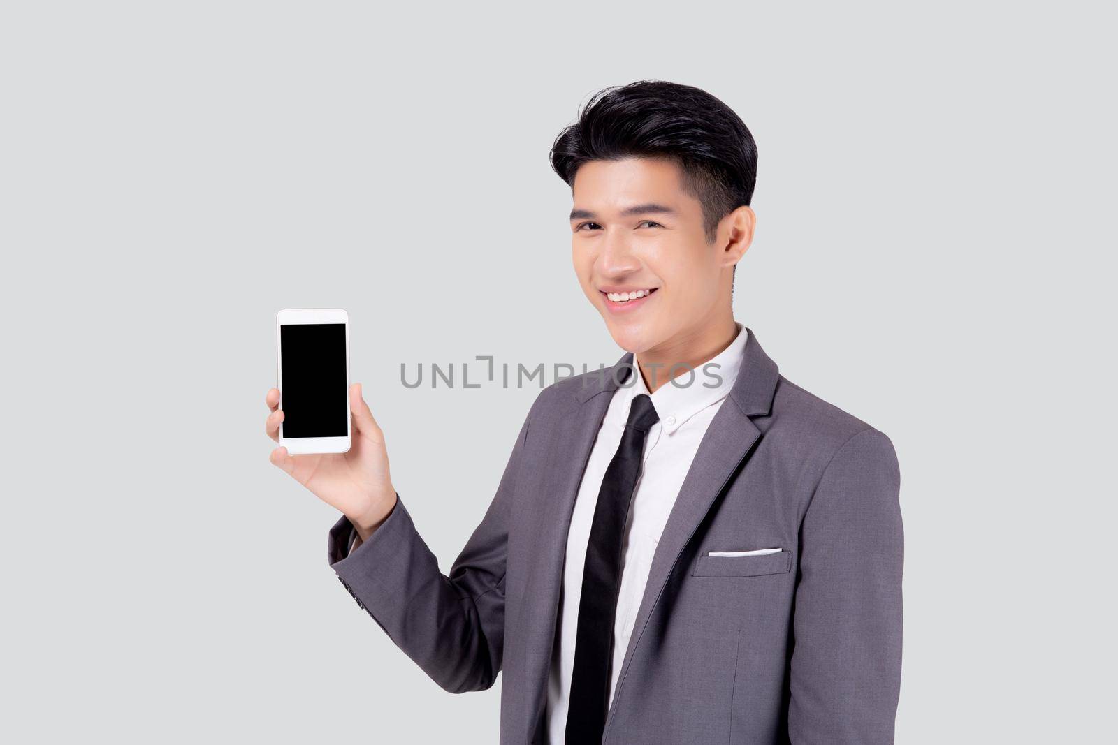 Portrait young asian business man showing and presenting smartphone with blank with success isolated on white background, businessman standing and holding phone, communication concept. by nnudoo