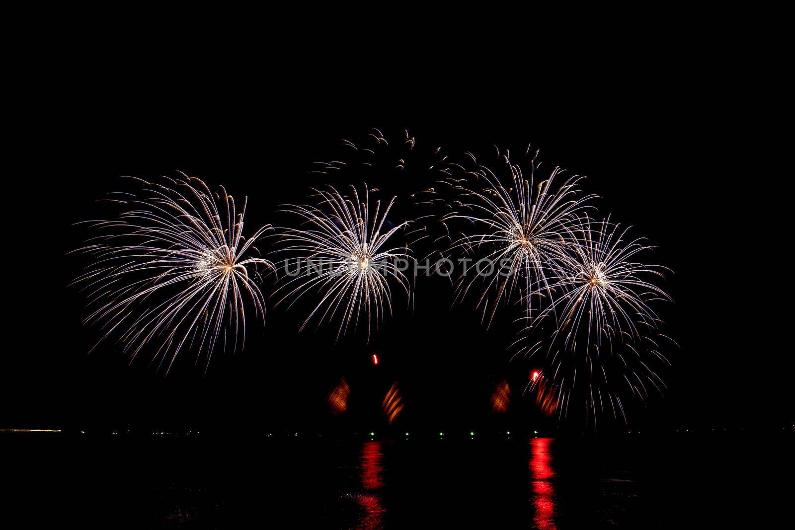 Many flashing colorful fireworks in event amazing with black background celebrate New Year, holiday and festival in night.