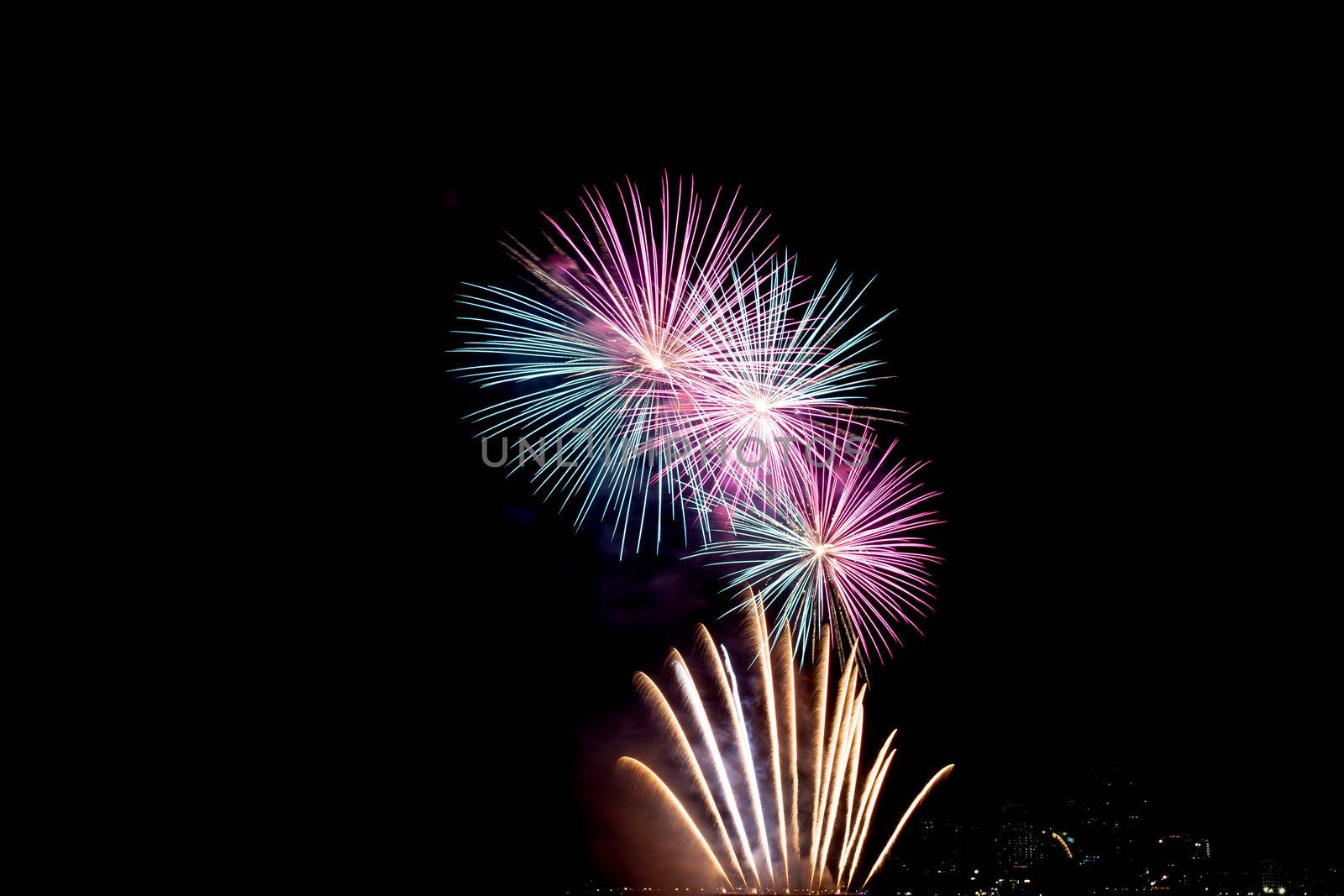 Many flashing colorful fireworks in event amazing with black background celebrate New Year, holiday and festival in night.