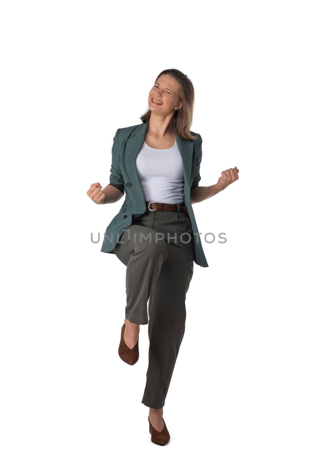 Young business woman winner holding fists isolated on white background full length studio portrait