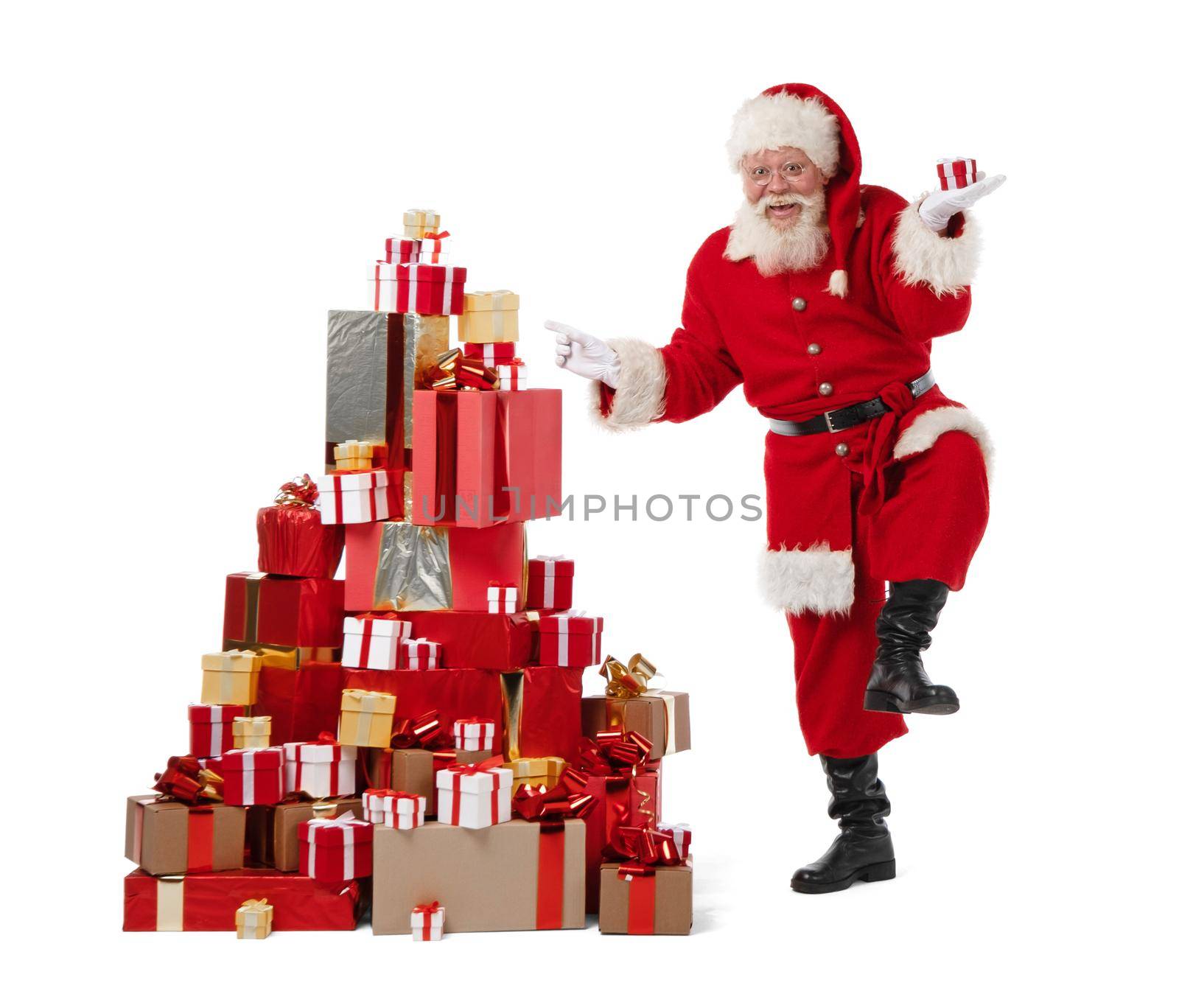Santa Claus dancing near large pile of Christmas gifts isolated on white background